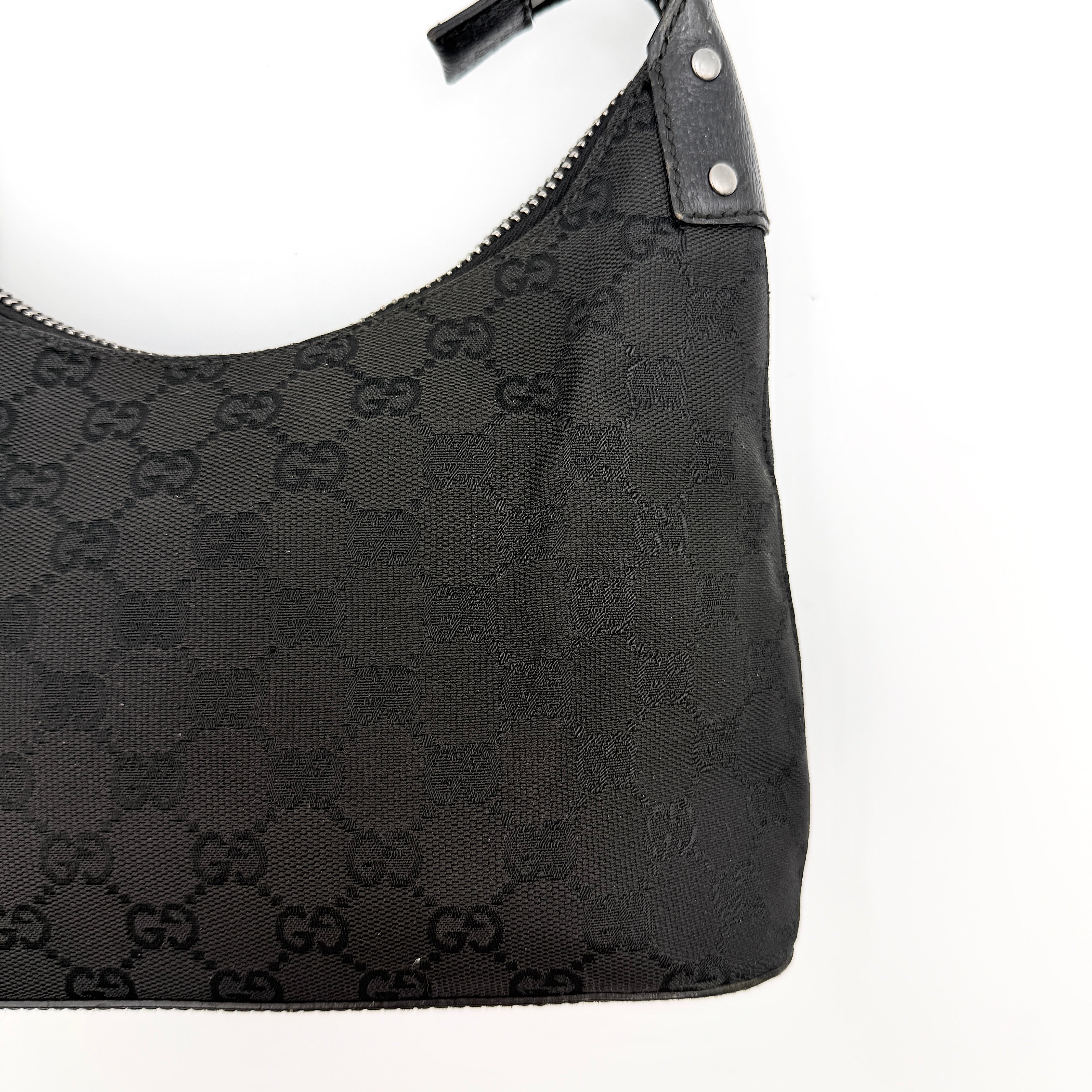 Gucci GG Monogram Lock Hobo Shoulder Bag in black jacquard canvas with leather trim and silver-tone hardware, shown on a white background.