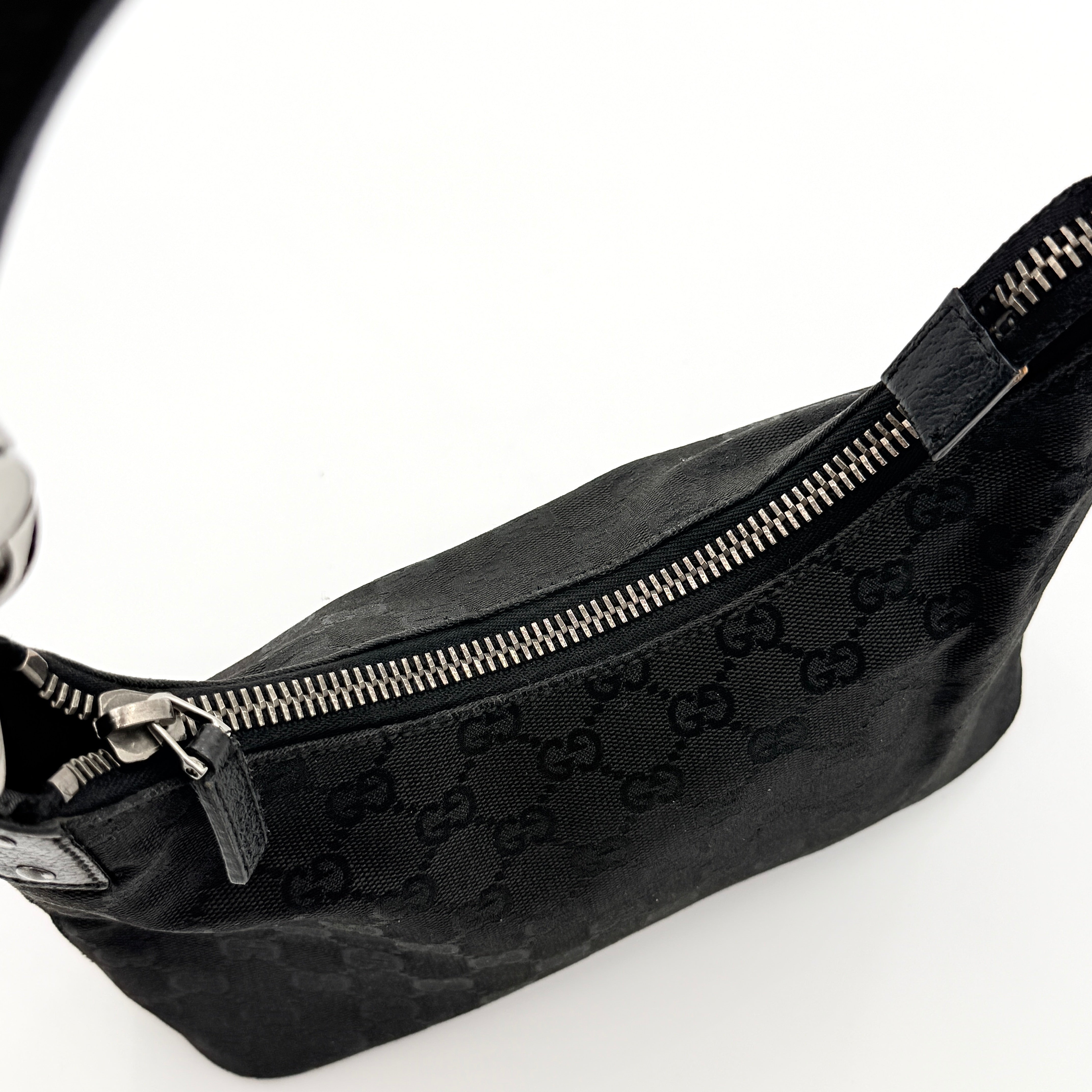 Gucci GG Monogram Lock Hobo Shoulder Bag in black jacquard canvas with leather trim and silver-tone hardware, shown on a white background.
