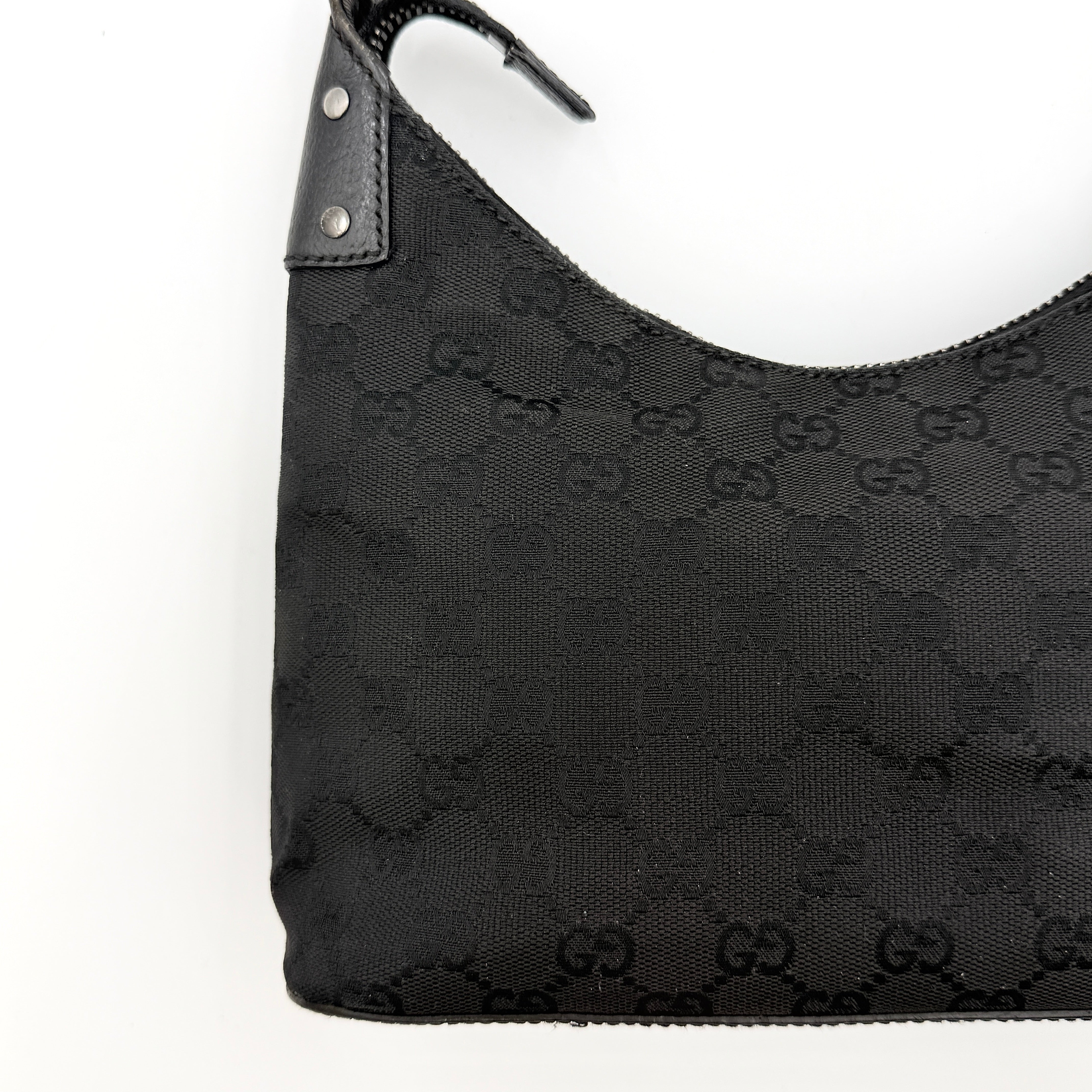 Gucci GG Monogram Lock Hobo Shoulder Bag in black jacquard canvas with leather trim and silver-tone hardware, shown on a white background.