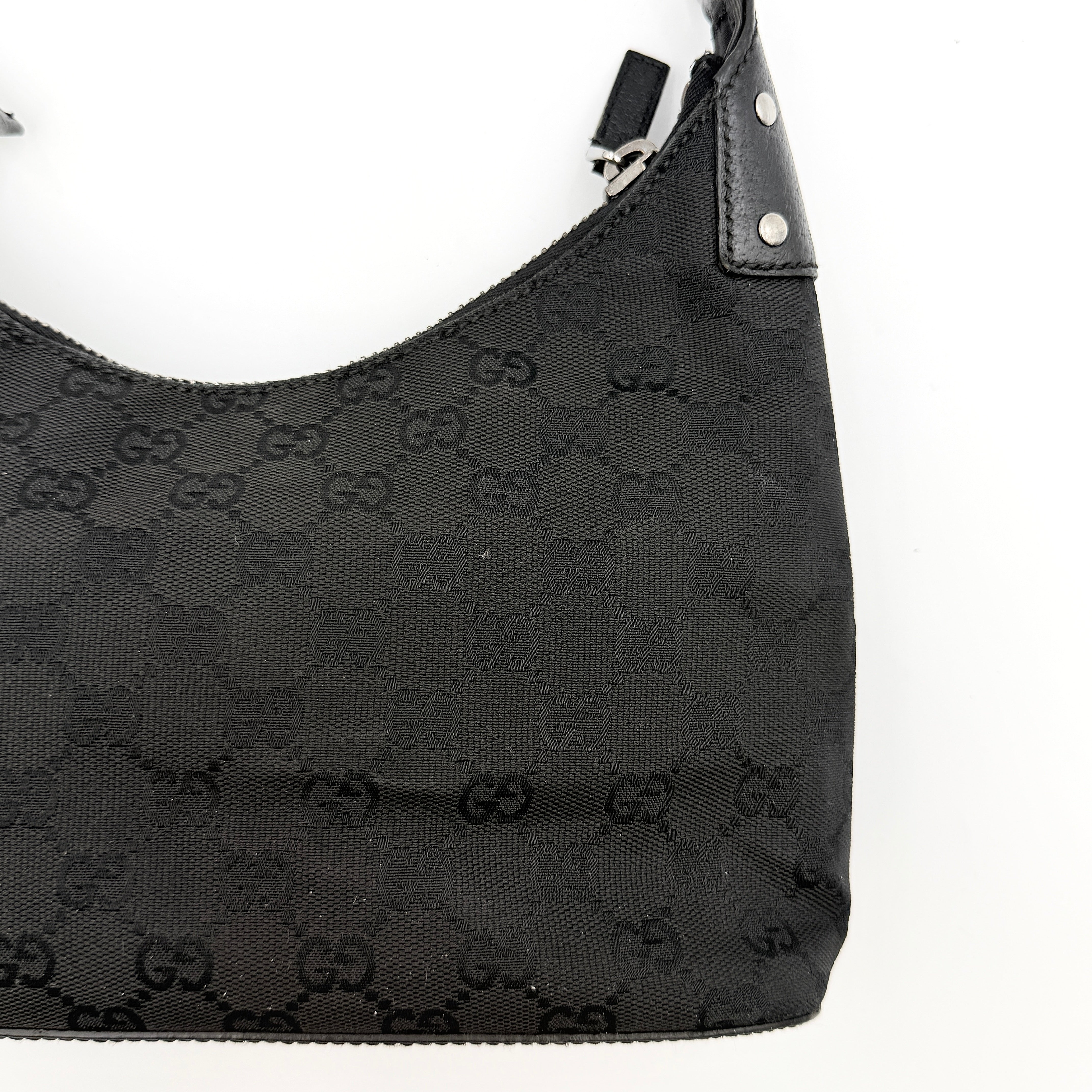 Gucci GG Monogram Lock Hobo Shoulder Bag in black jacquard canvas with leather trim and silver-tone hardware, shown on a white background.