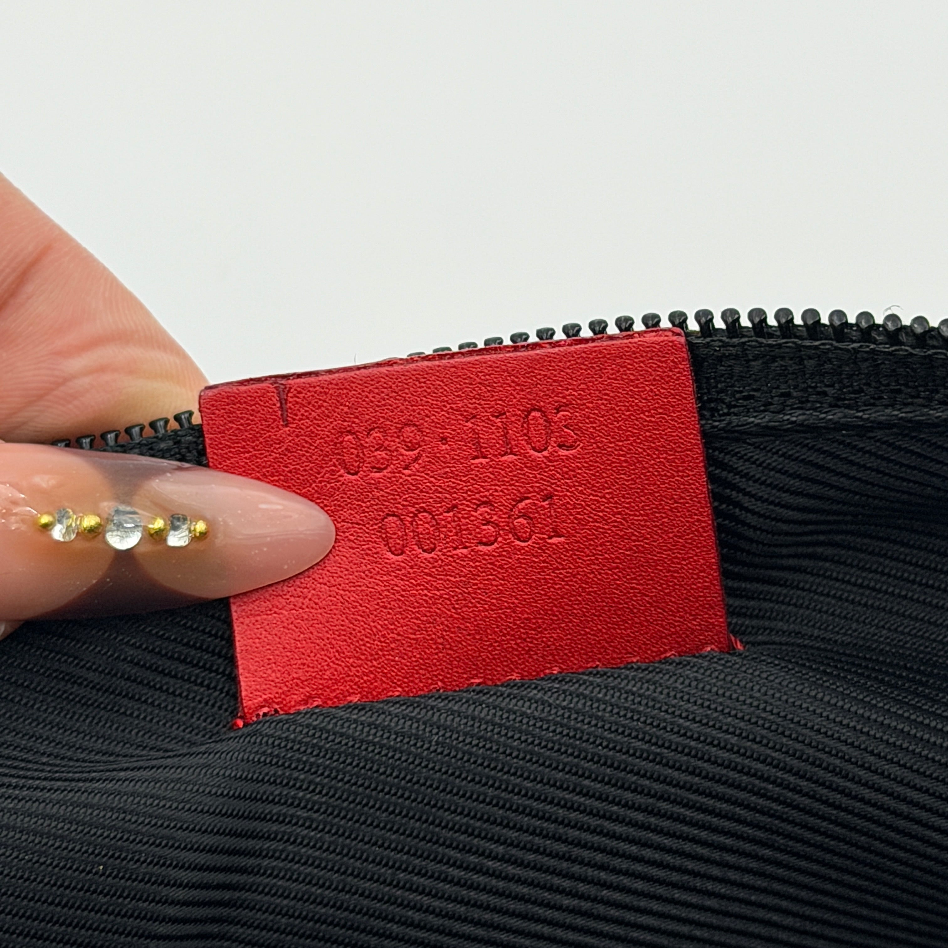 Gucci GG Monogram Pochette Boat Shoulder Bag in grey canvas with red leather trim and gold plaque, shown against a plain background.