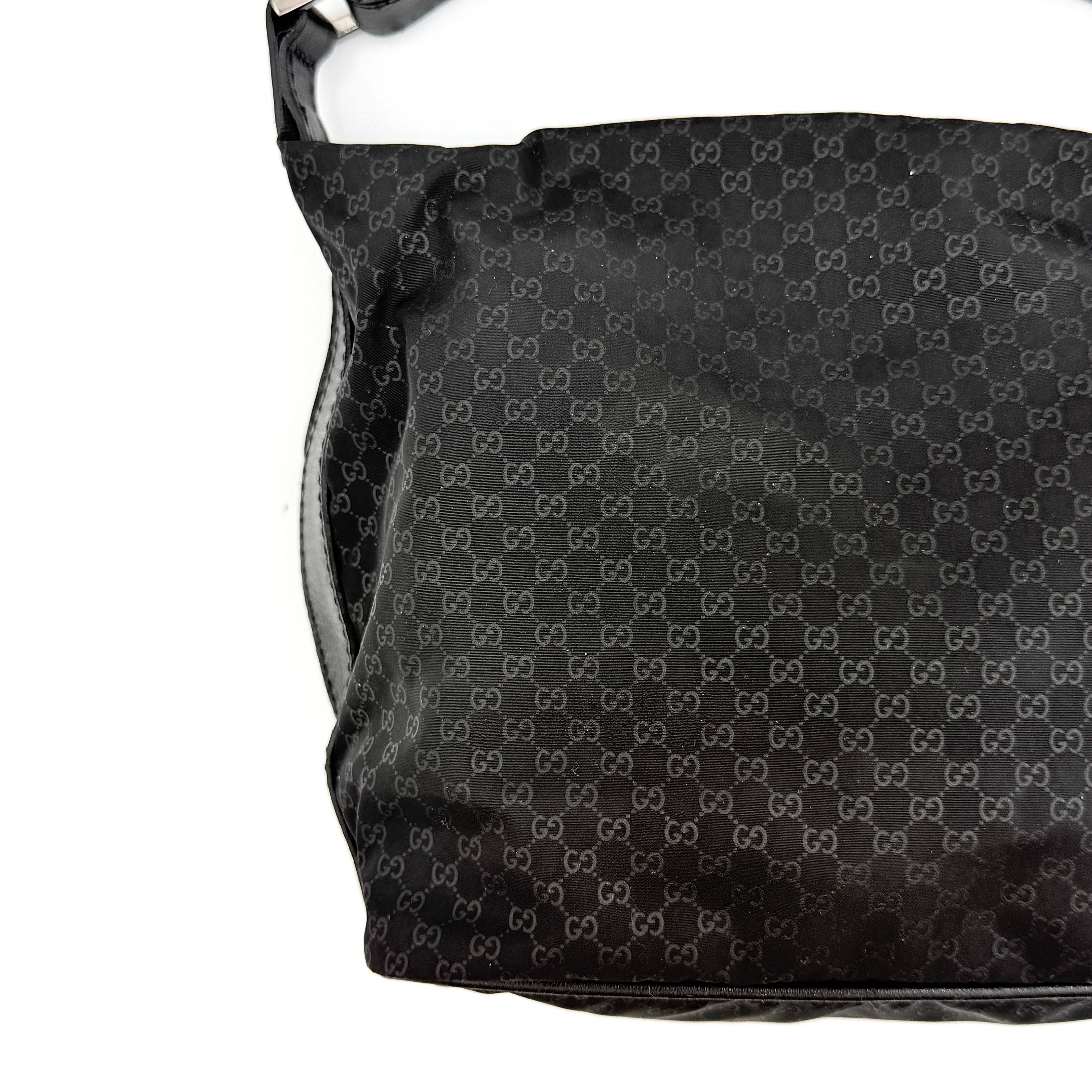 Gucci GG Monogram Mini Hobo black nylon shoulder bag with leather trim and silver-tone hardware, displayed on a plain background.