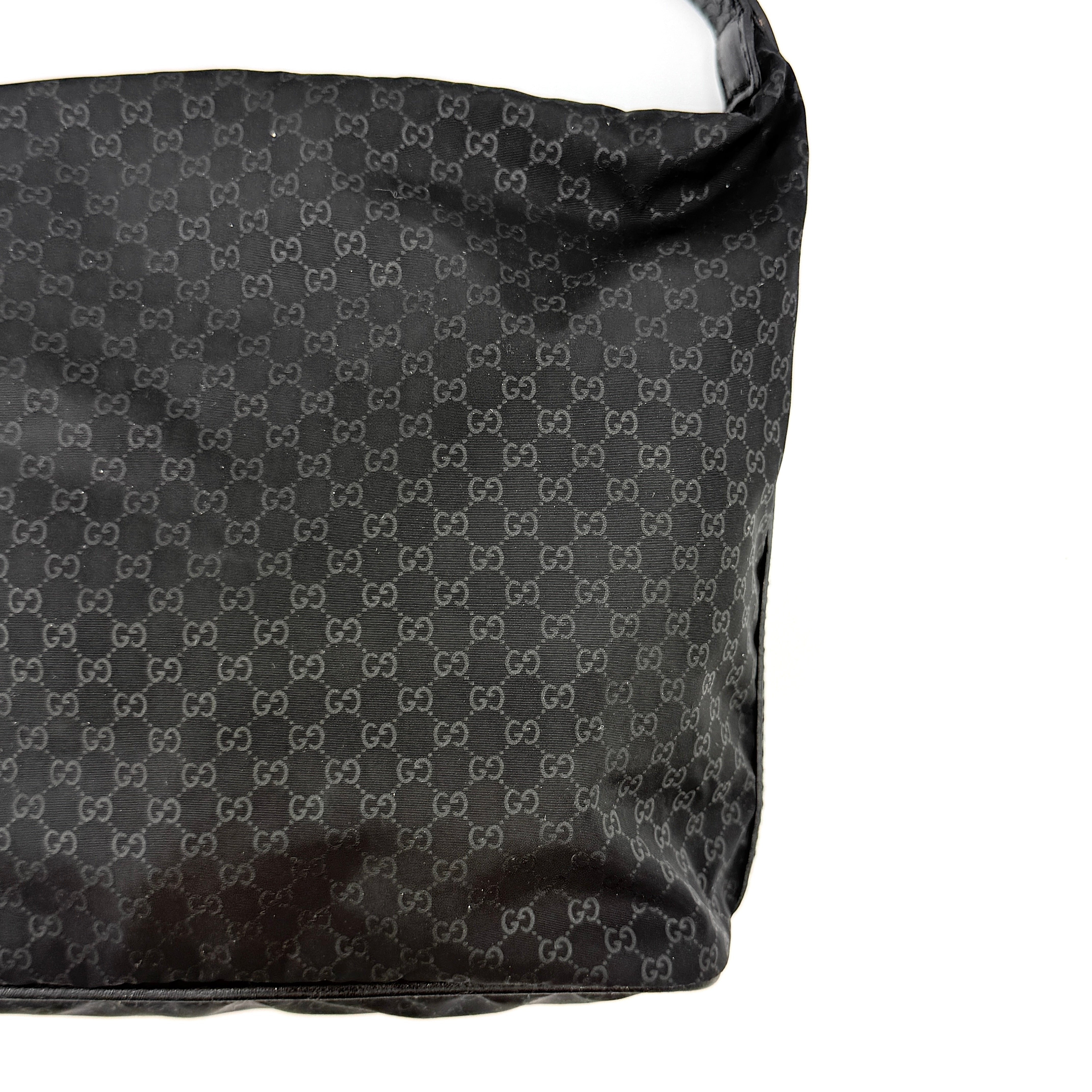 Gucci GG Monogram Mini Hobo black nylon shoulder bag with leather trim and silver-tone hardware, displayed on a plain background.