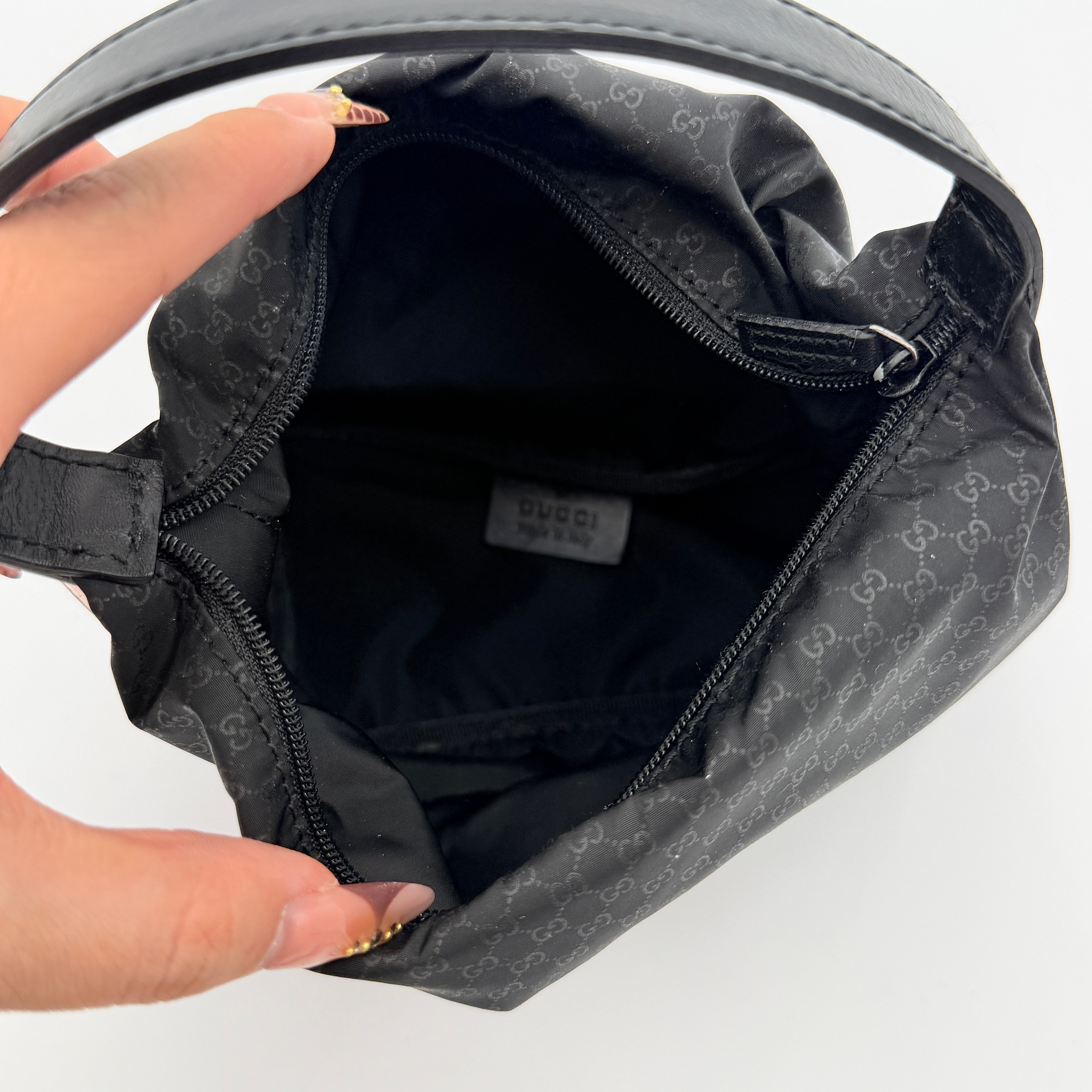 Gucci GG Monogram Mini Hobo black nylon shoulder bag with leather trim and silver-tone hardware, displayed on a plain background.