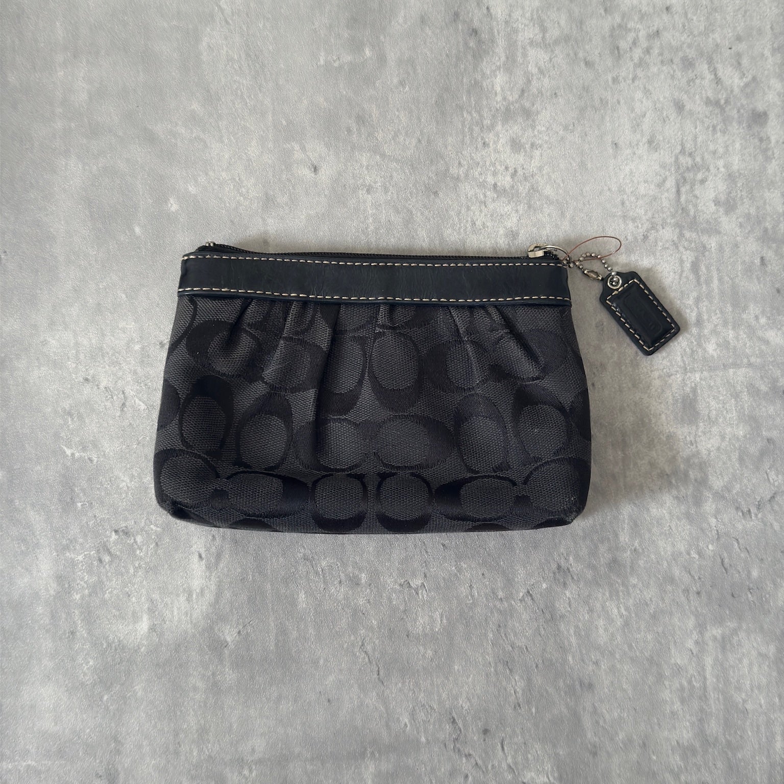 Coach Signature Pleated Black Wristlet with iconic monogram pattern, black leather trim, and red fabric interior, vintage condition.