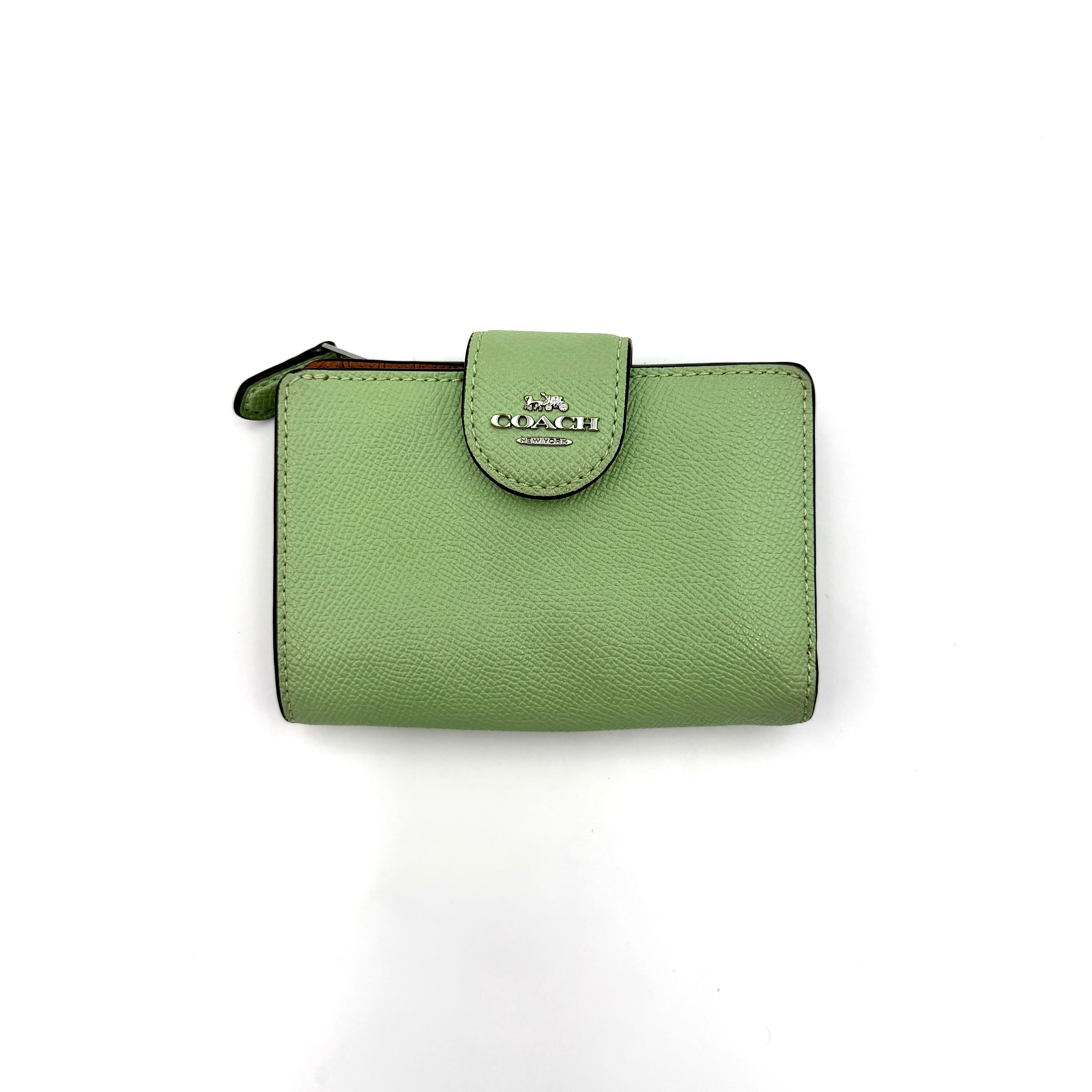 Coach Medium Corner Zip Wallet in fresh green pebbled leather with silver logo hardware and organised tan interior.