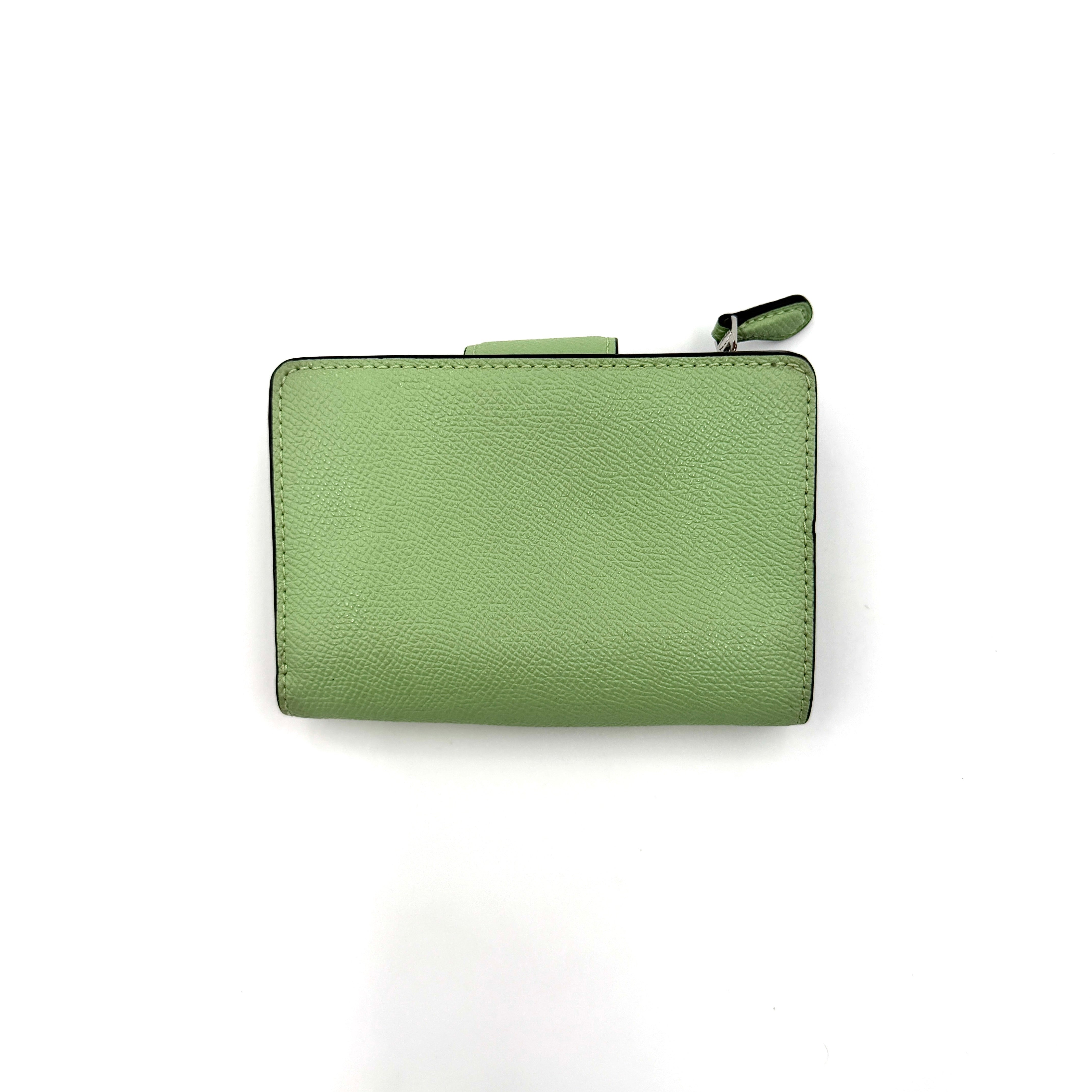 Coach Medium Corner Zip Wallet in fresh green pebbled leather with silver logo hardware and organised tan interior.