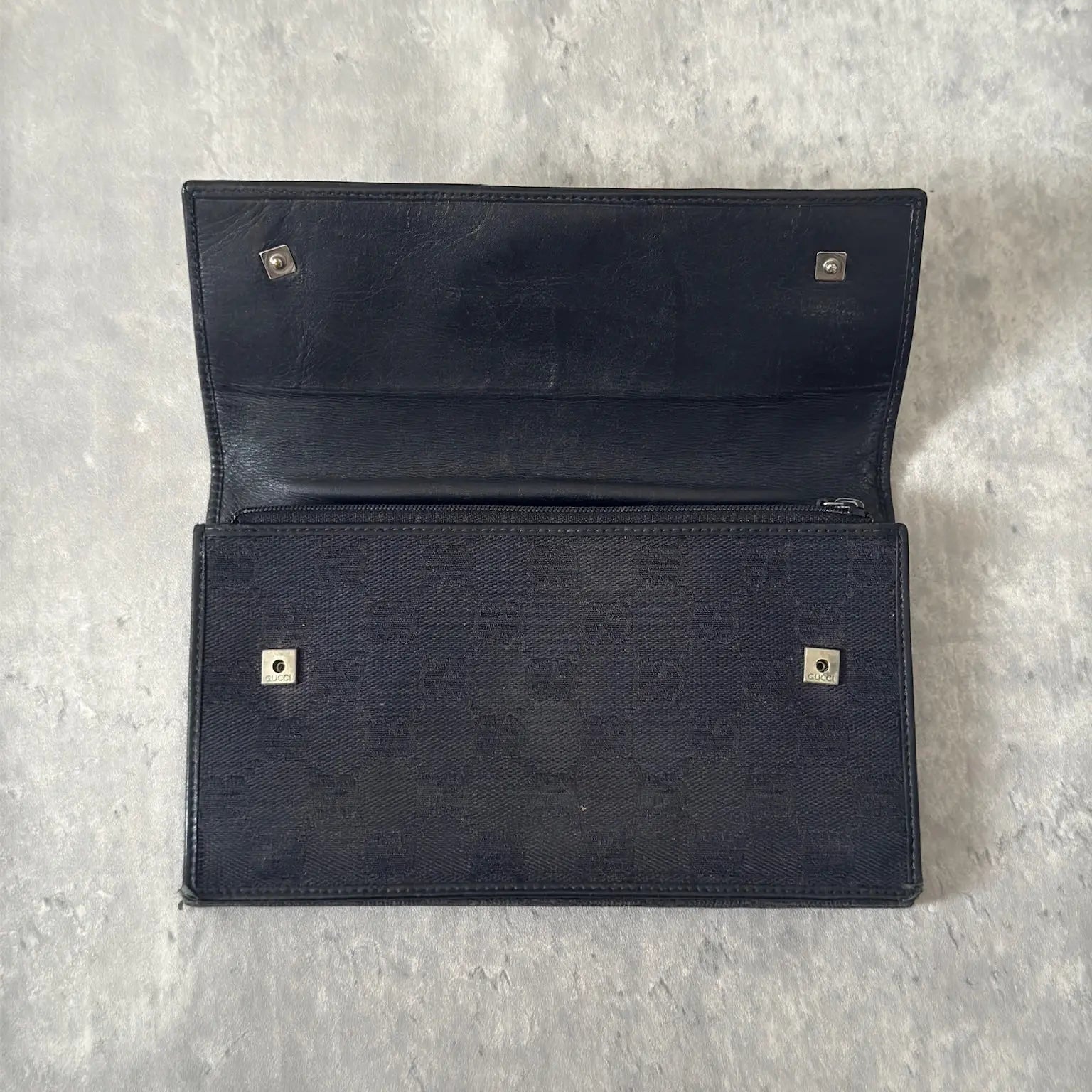 Gucci Monogram Black Bifold Long Wallet with snap-button closure and multiple compartments.