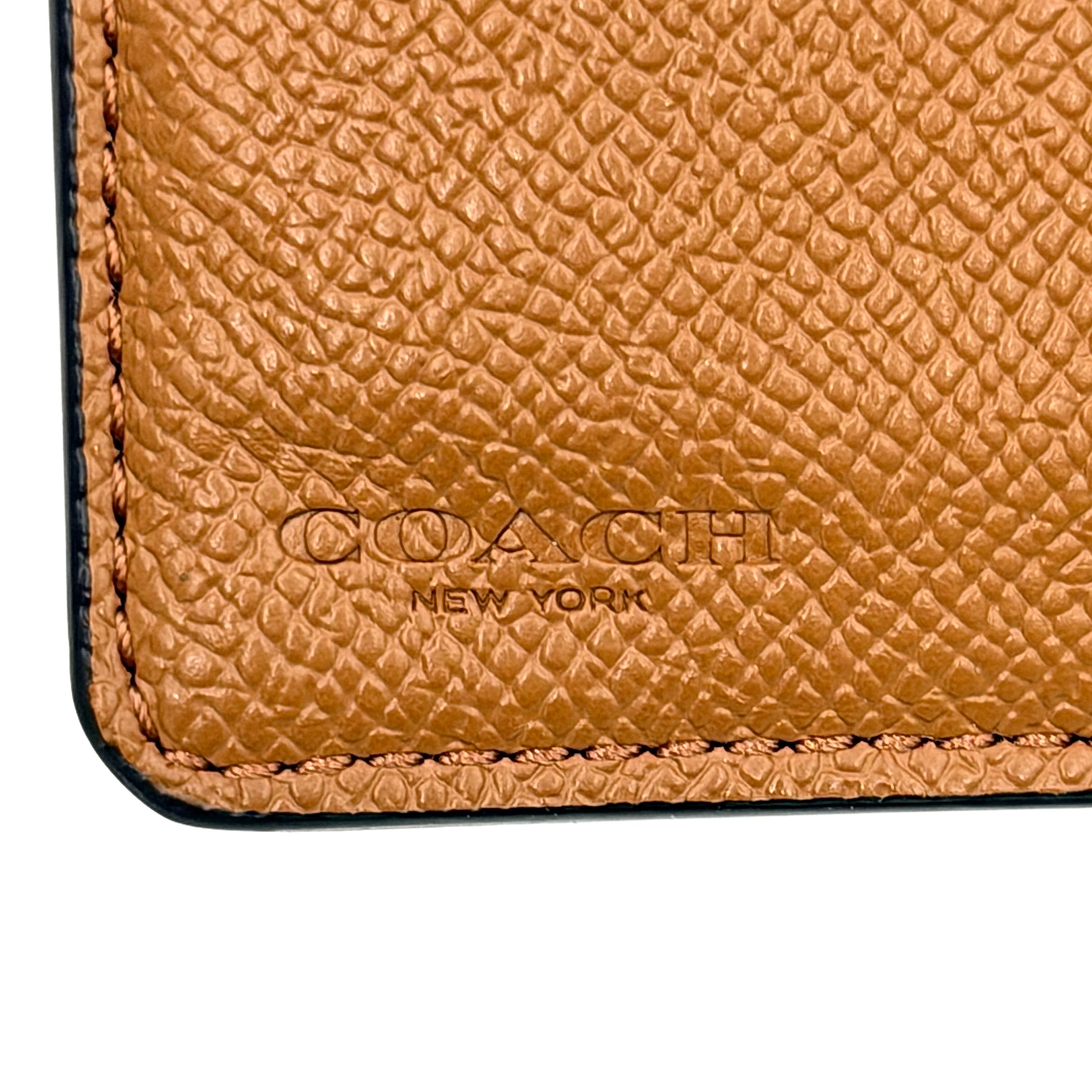 Coach Medium Corner Zip Wallet in fresh green pebbled leather with silver logo hardware and organised tan interior.