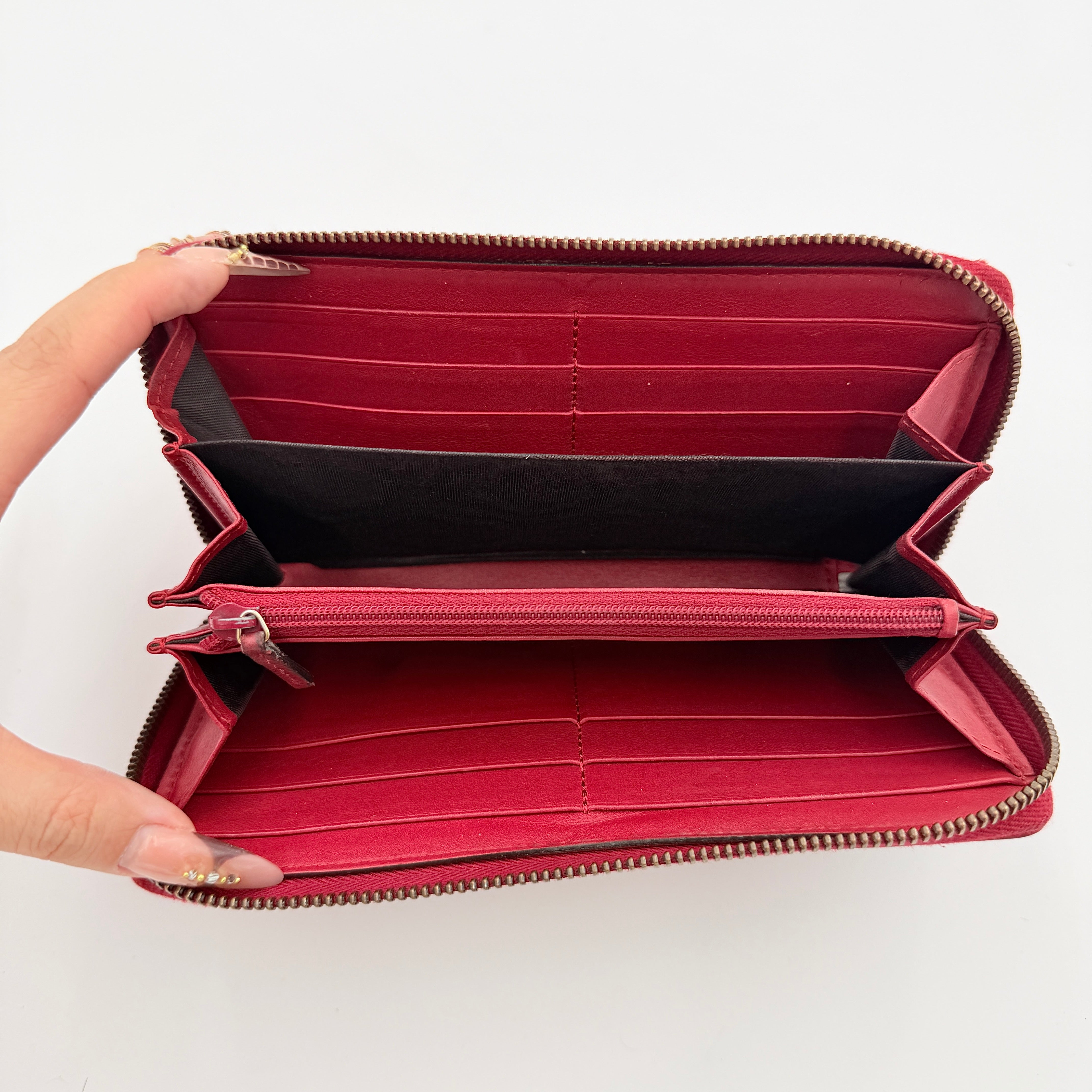 Gucci GG Marmont quilted long wallet in red leather with gold hardware displayed flat against a white background.