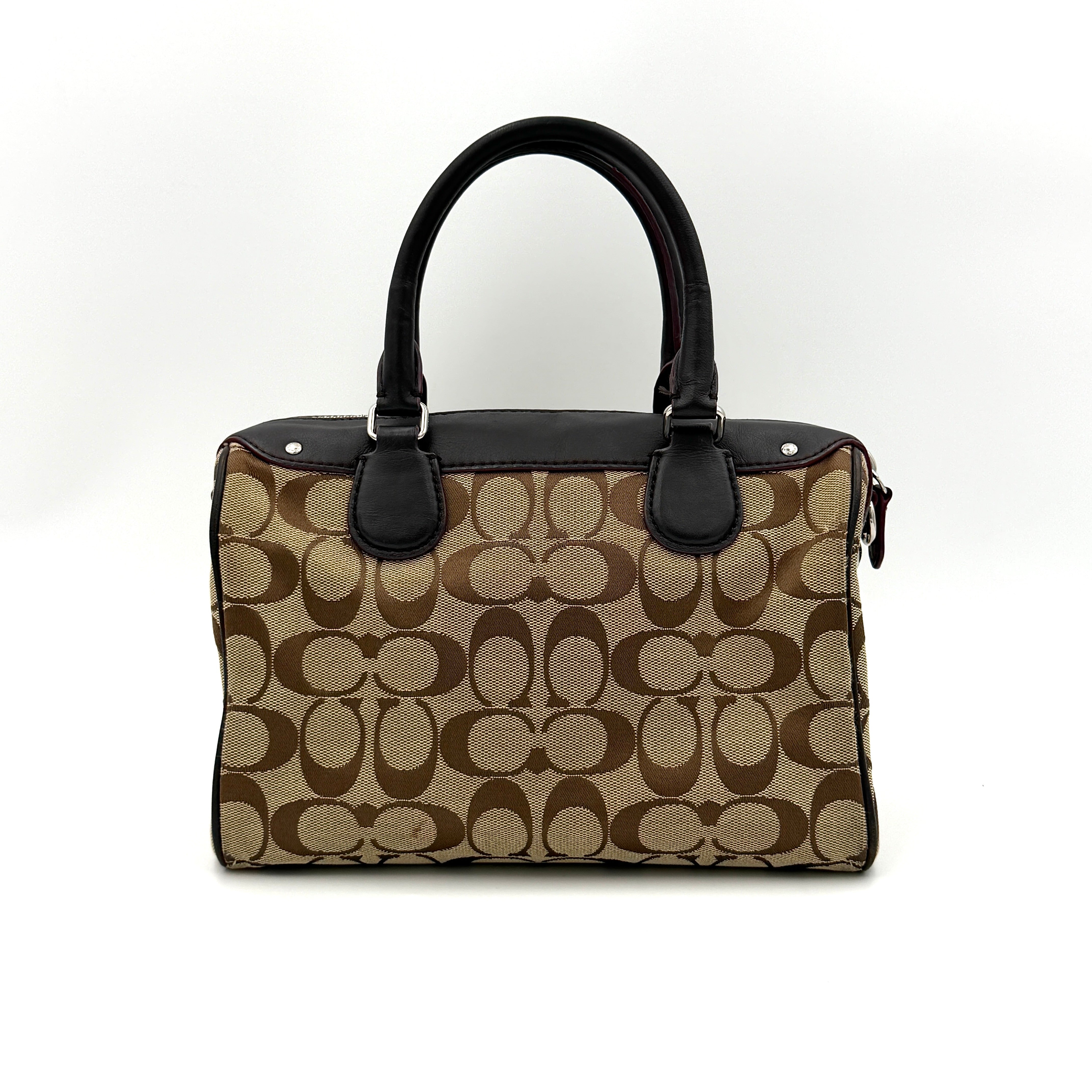 Coach Mini Bennett Boston Bag in beige monogram canvas with brown leather trim, dual handles, and detachable crossbody strap.