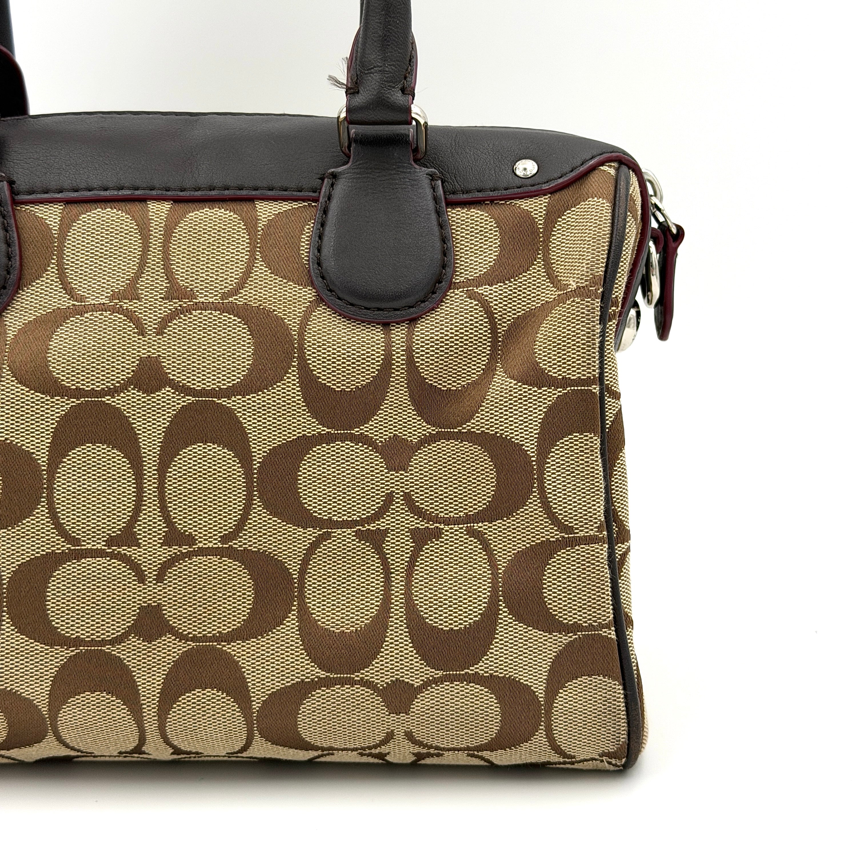 Coach Mini Bennett Boston Bag in beige monogram canvas with brown leather trim, dual handles, and detachable crossbody strap.