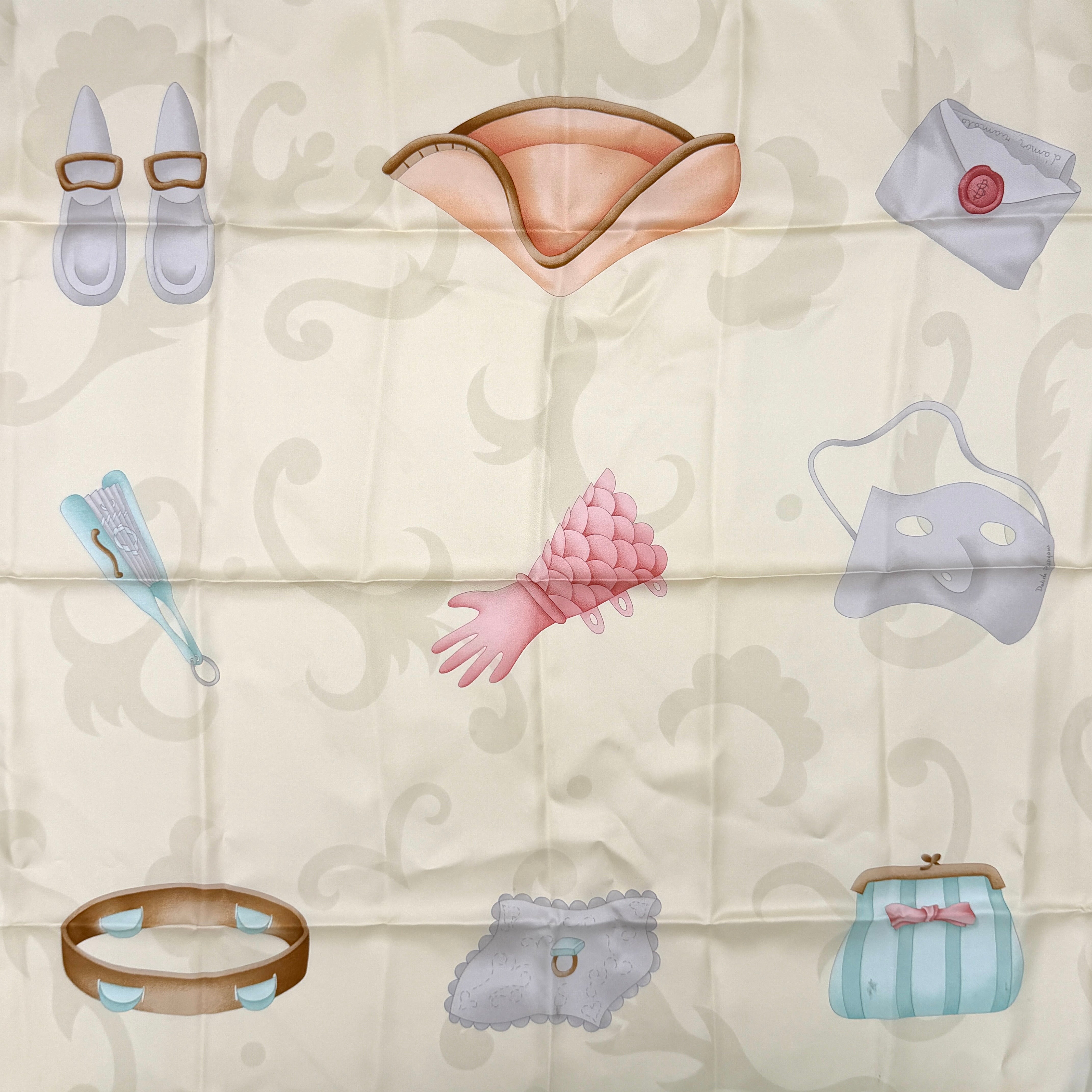 Bvlgari silk scarf in light blue and cream, featuring playful accessory illustrations and baroque-style borders.