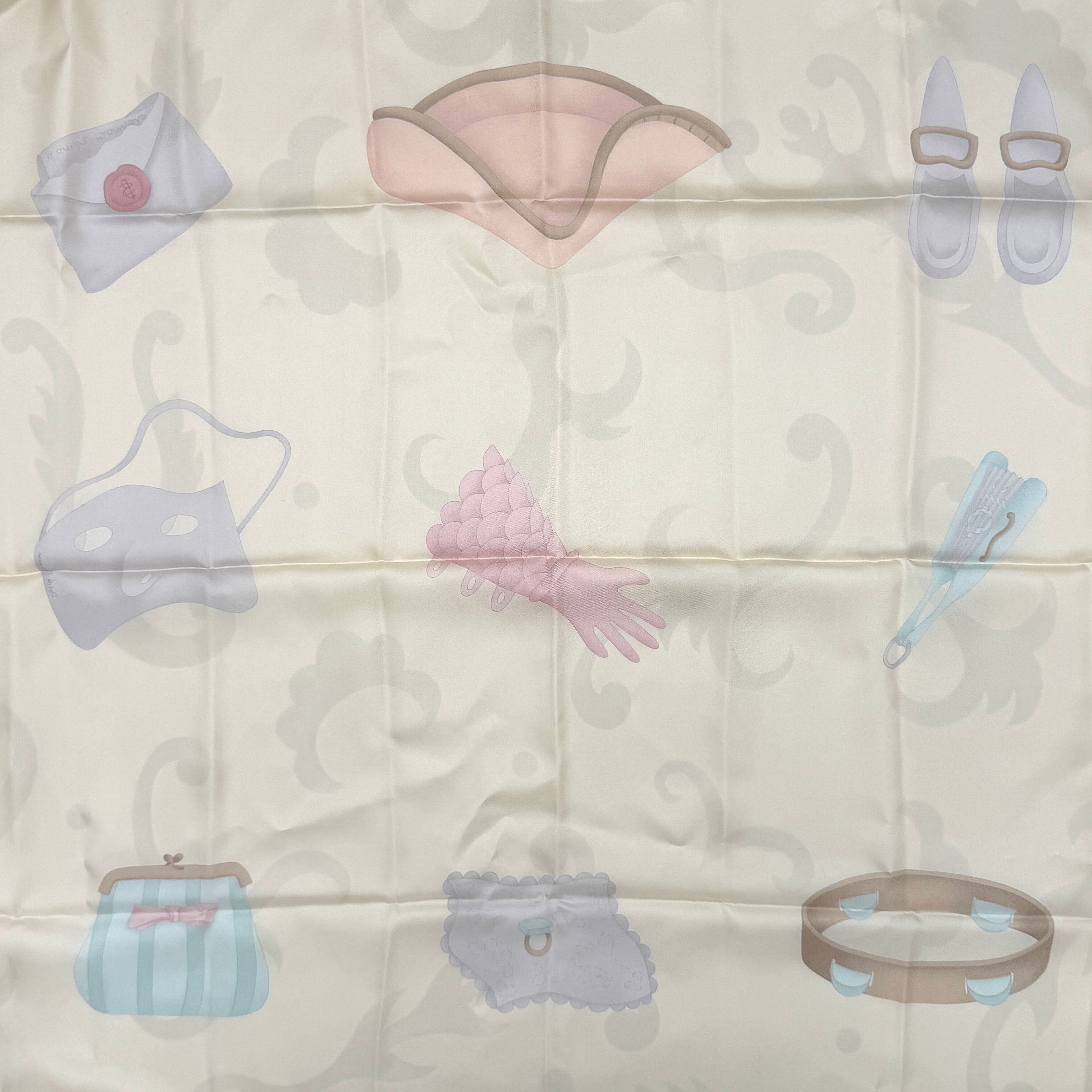 Bvlgari silk scarf in light blue and cream, featuring playful accessory illustrations and baroque-style borders.