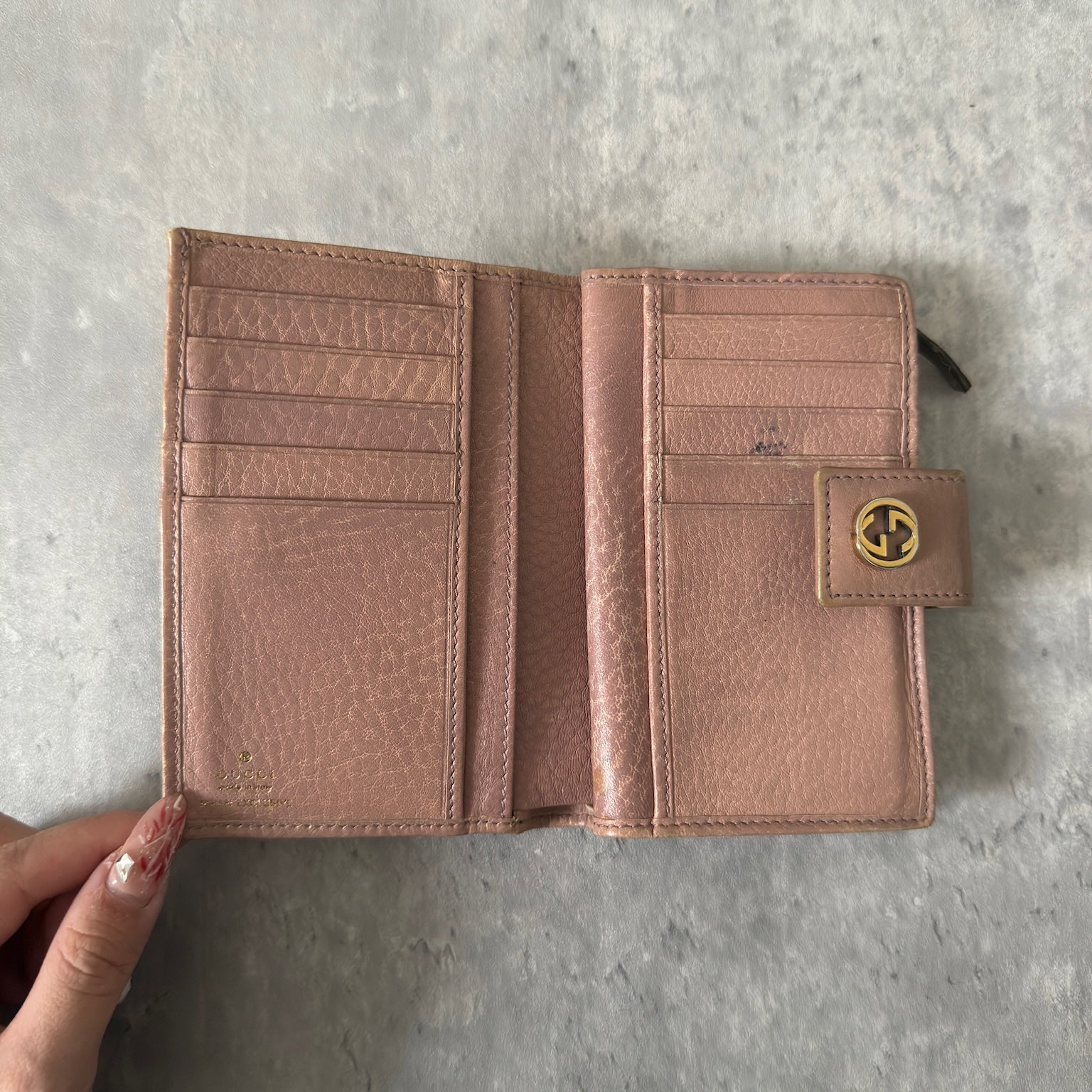 Gucci GG Logo Canvas Bifold Wallet in Pink/Beige with snap closure and multiple compartments, displaying minimal signs of wear.