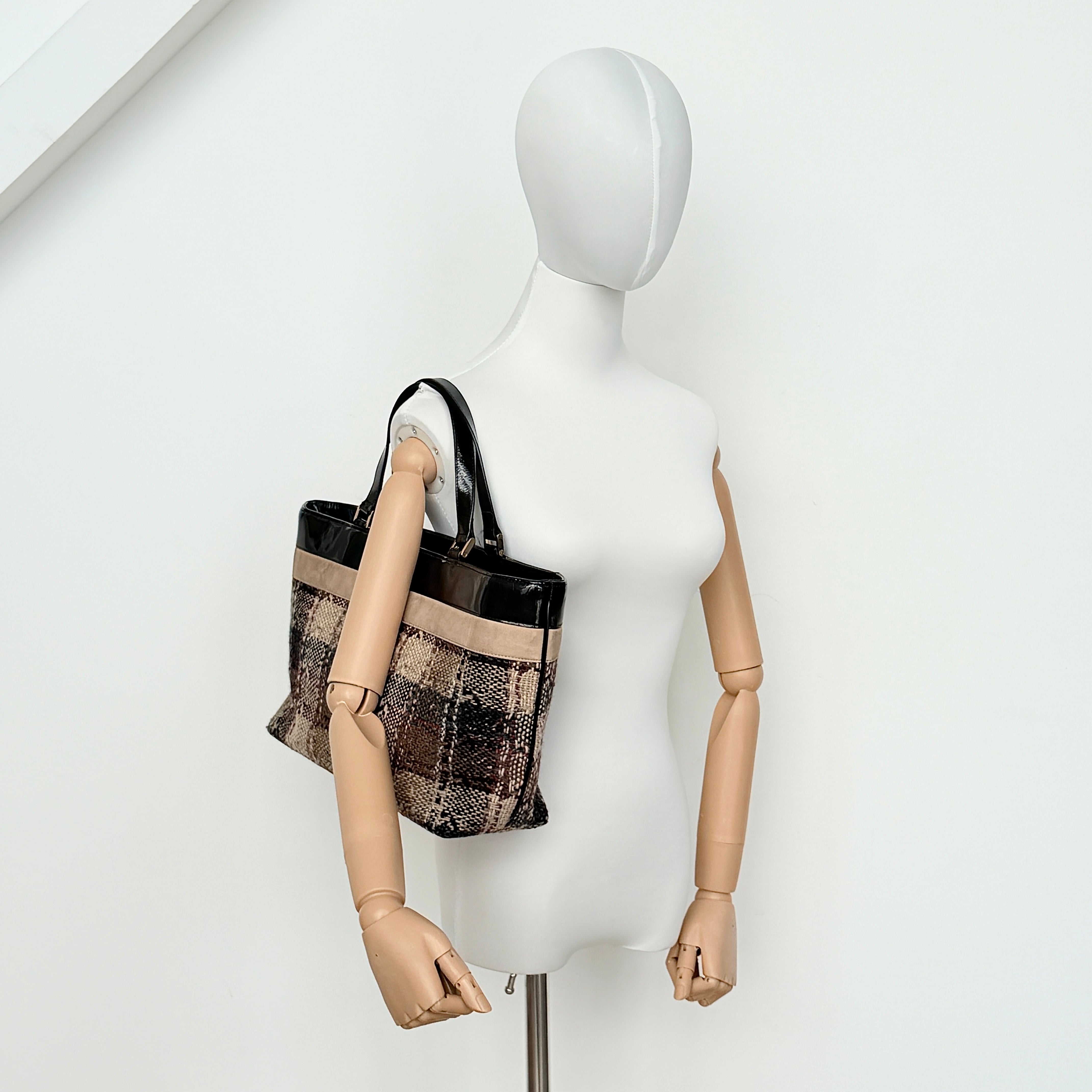 Burberry Nova Check Wool Shoulder Bag in beige and black wool with patent leather trim and double handles.