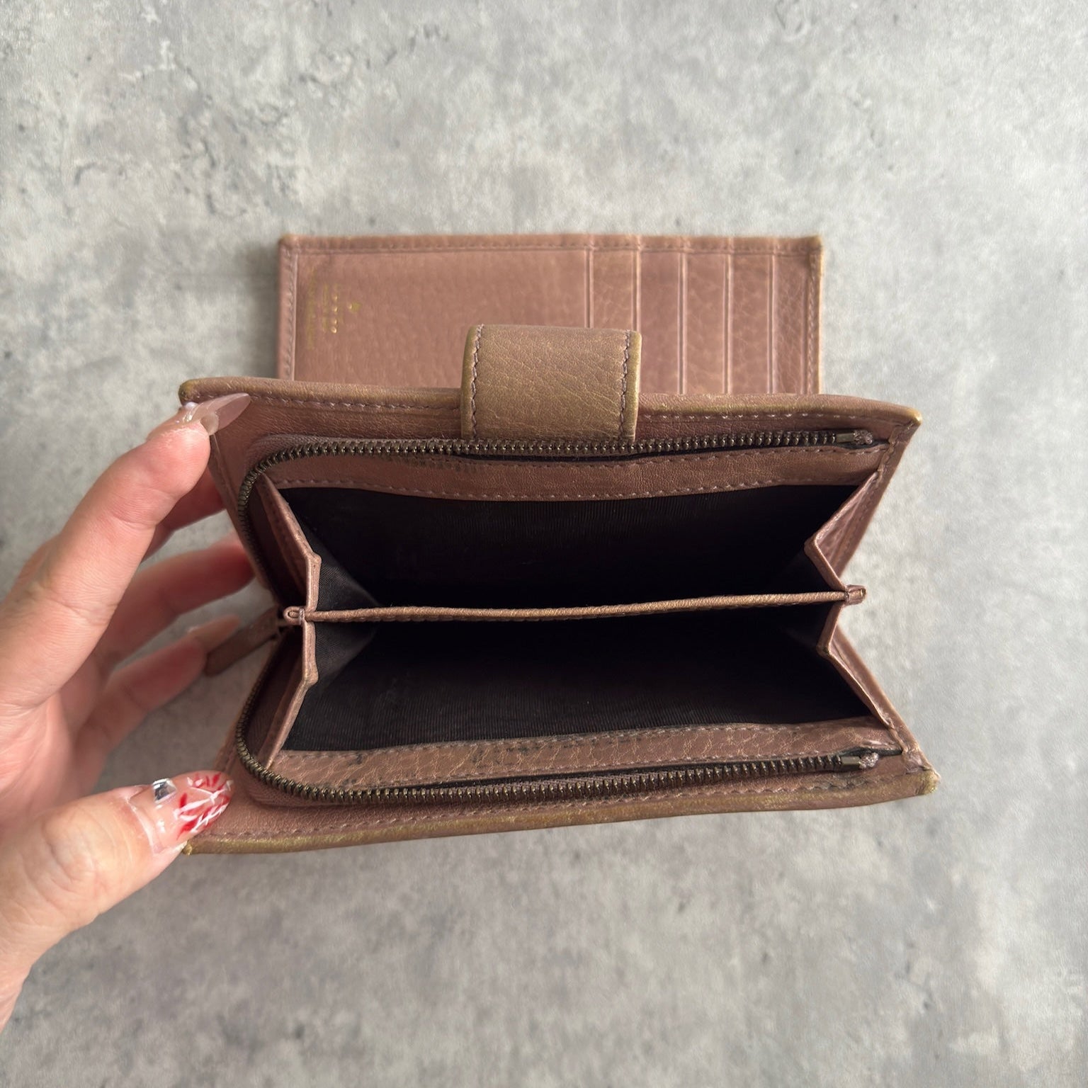 Gucci GG Logo Canvas Bifold Wallet in Pink/Beige with snap closure and multiple compartments, displaying minimal signs of wear.