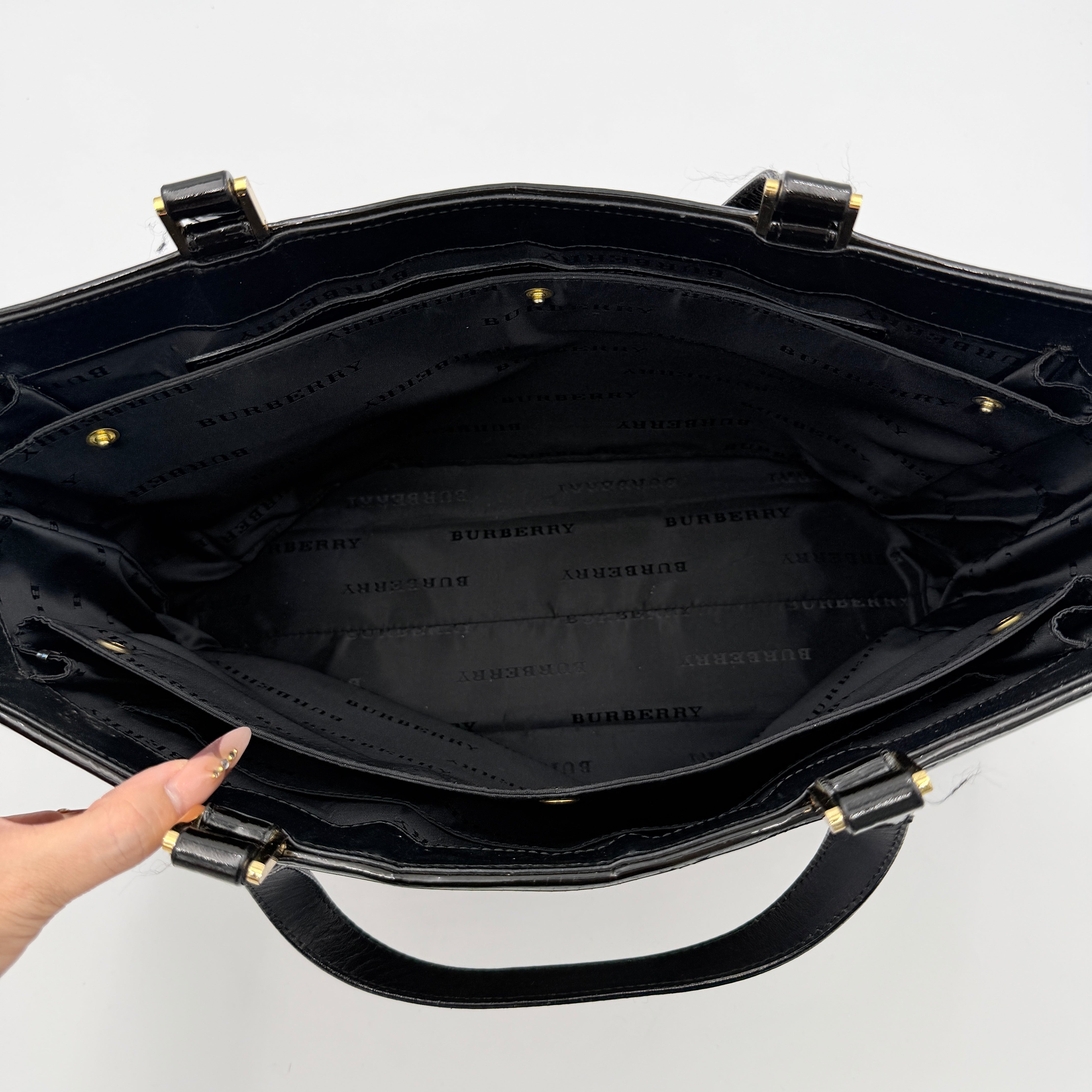 Burberry Nova Check Wool Shoulder Bag in beige and black wool with patent leather trim and double handles.