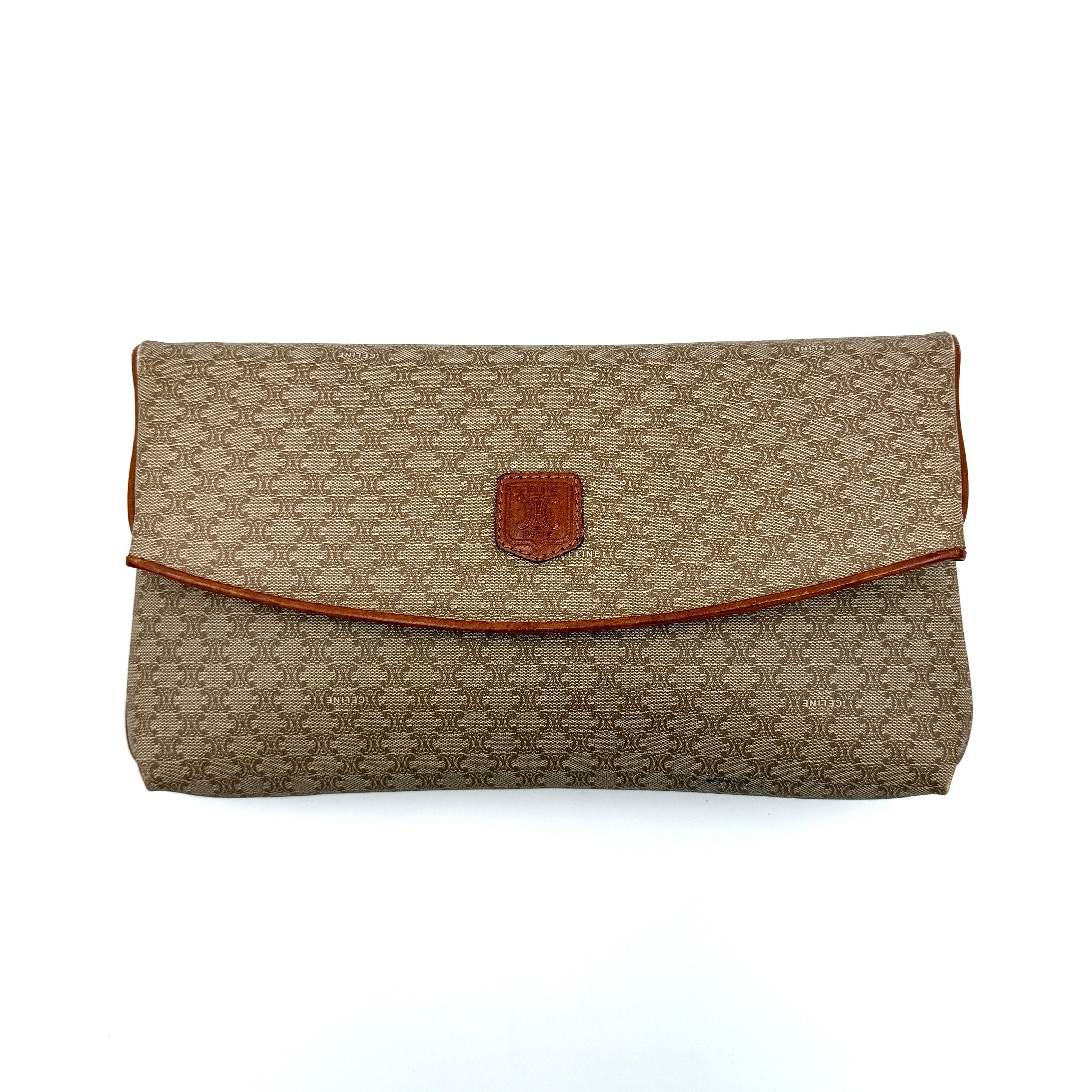 The Celine Macadam Clutch Bag in beige, featuring the iconic monogram canvas and tan leather trim, shown neatly closed with its signature emblem on the flap.