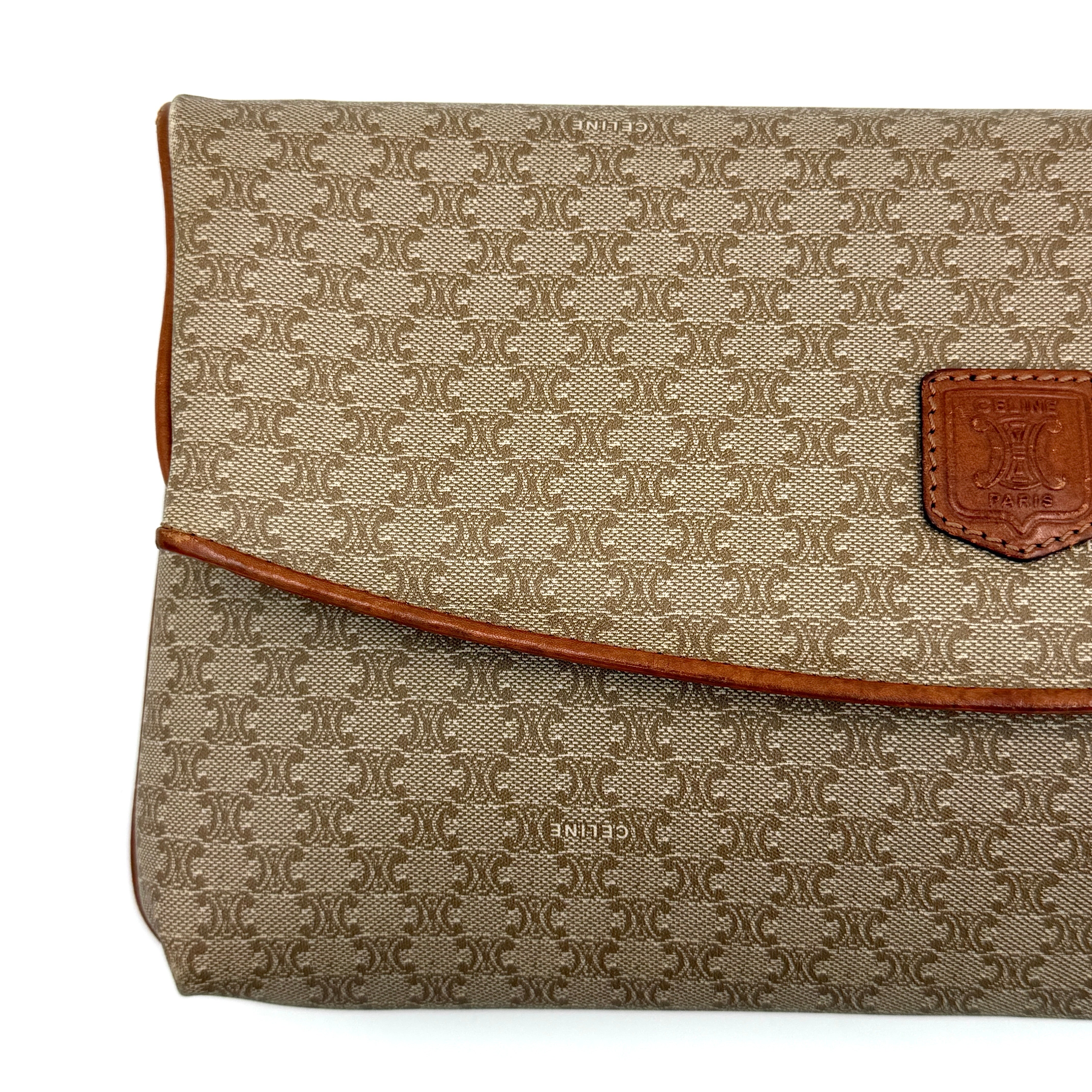 The Celine Macadam Clutch Bag in beige, featuring the iconic monogram canvas and tan leather trim, shown neatly closed with its signature emblem on the flap.