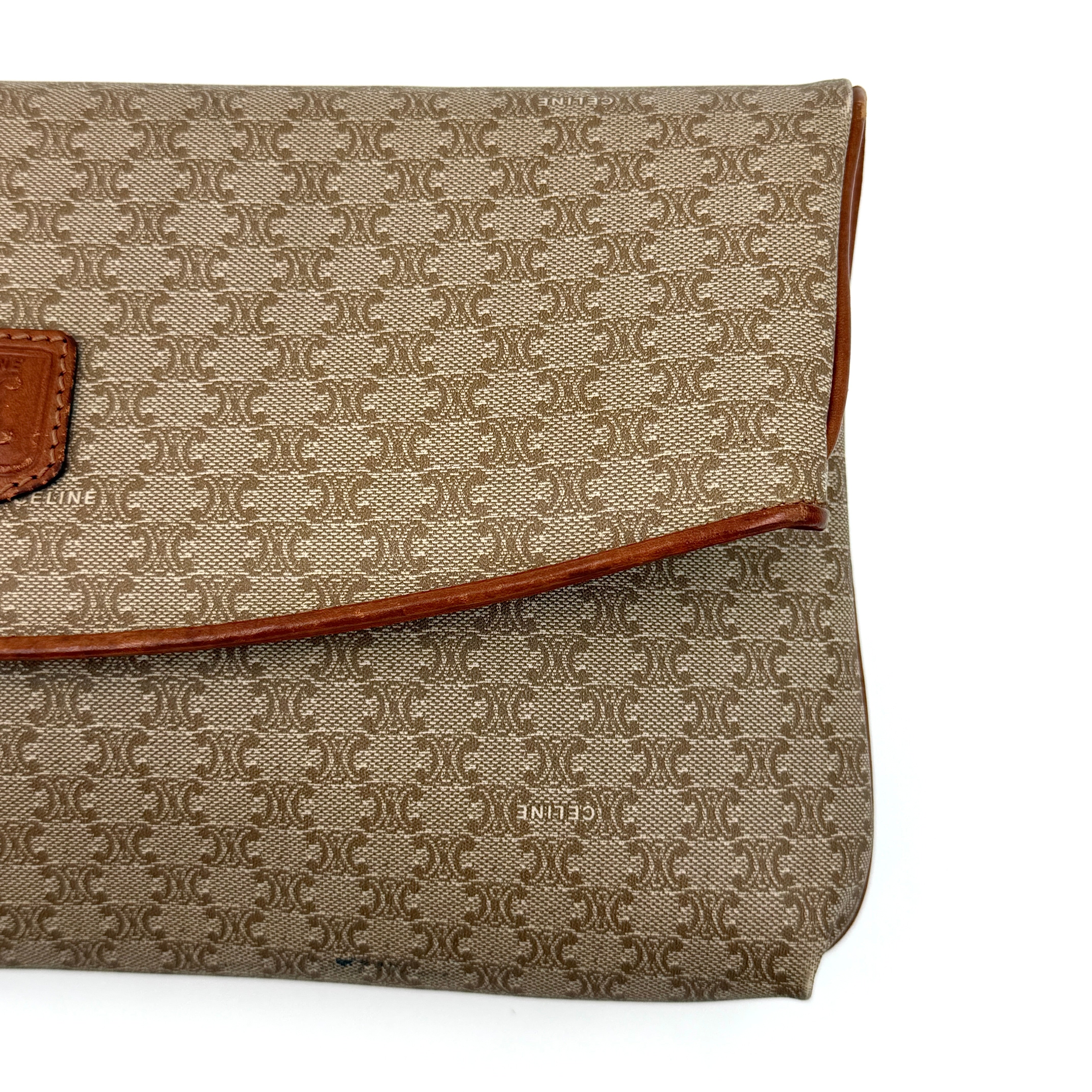 The Celine Macadam Clutch Bag in beige, featuring the iconic monogram canvas and tan leather trim, shown neatly closed with its signature emblem on the flap.