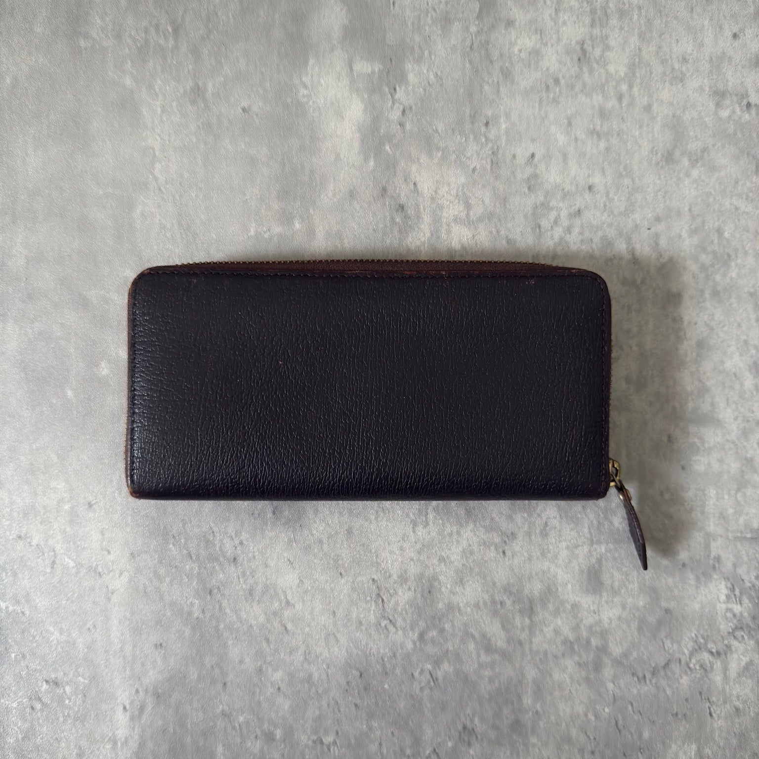 Vivienne Westwood Seditionaries Wallet, black leather, featuring the iconic gold-tone Orb emblem and a zip-around closure, interior detailed with brand's signature pattern.