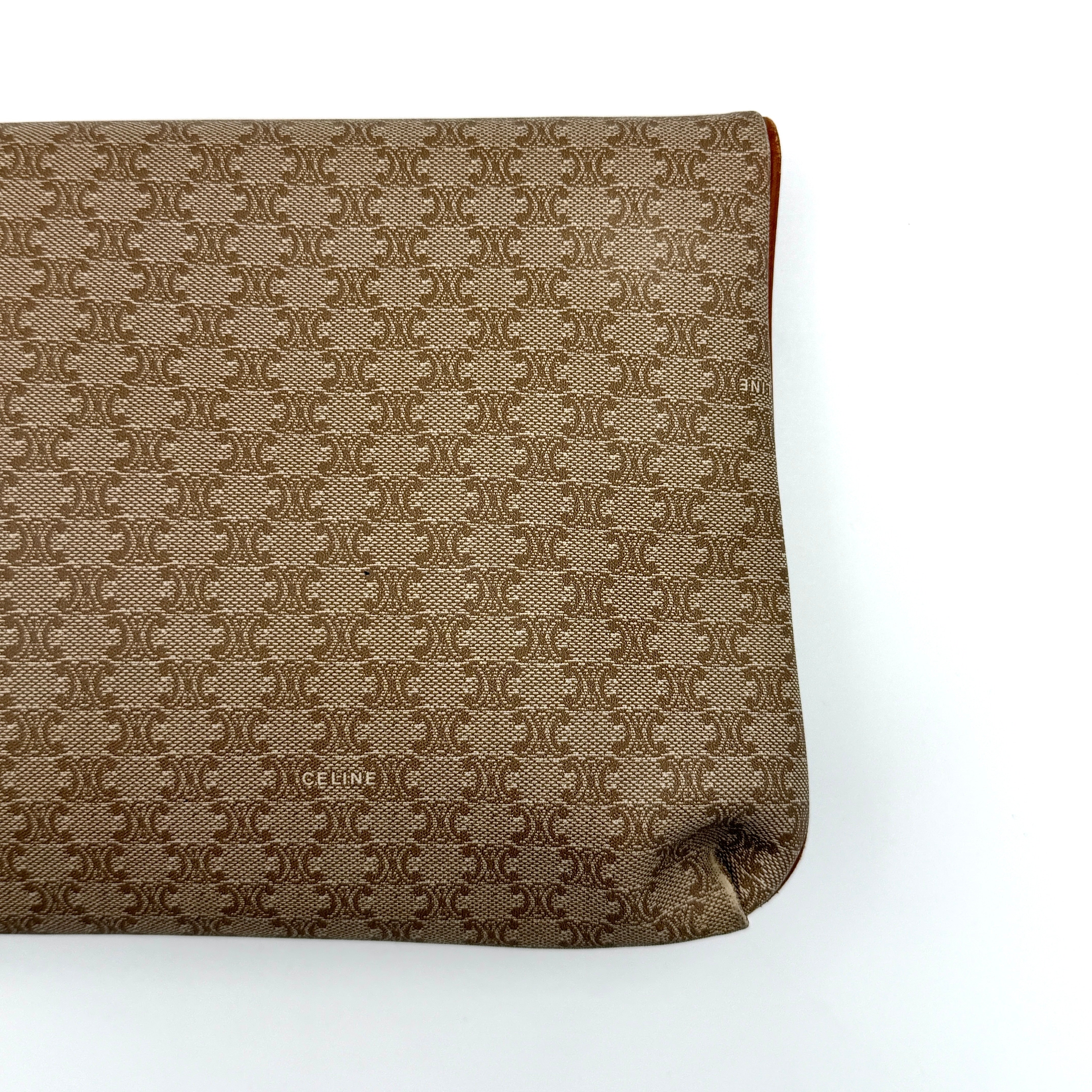The Celine Macadam Clutch Bag in beige, featuring the iconic monogram canvas and tan leather trim, shown neatly closed with its signature emblem on the flap.