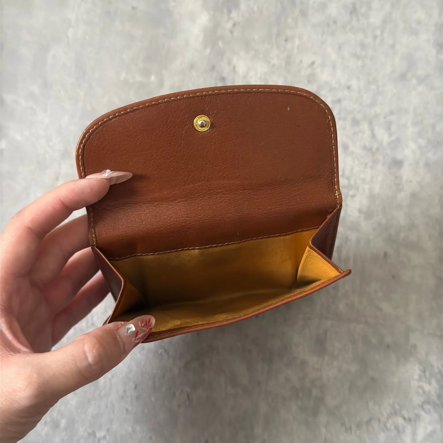 Gucci Signature Logo Clip Vintage Brown Wallet, crafted from smooth brown leather with a gold-tone logo clip.