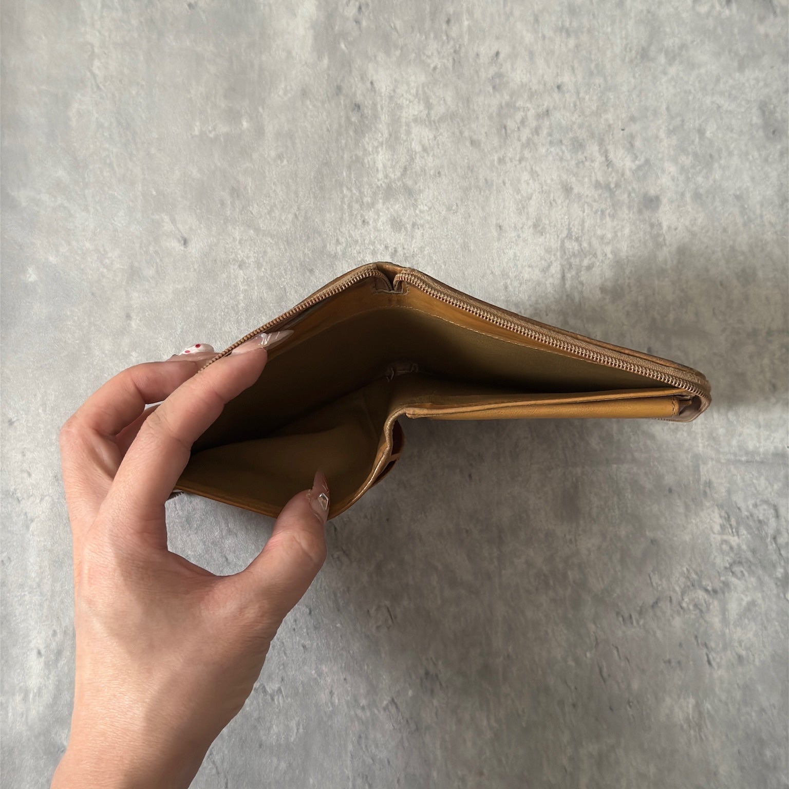 Celine Signature Macadam Triomphe Wallet in beige canvas with brown leather details, featuring multiple organizational compartments, embodying classic elegance and functionality.