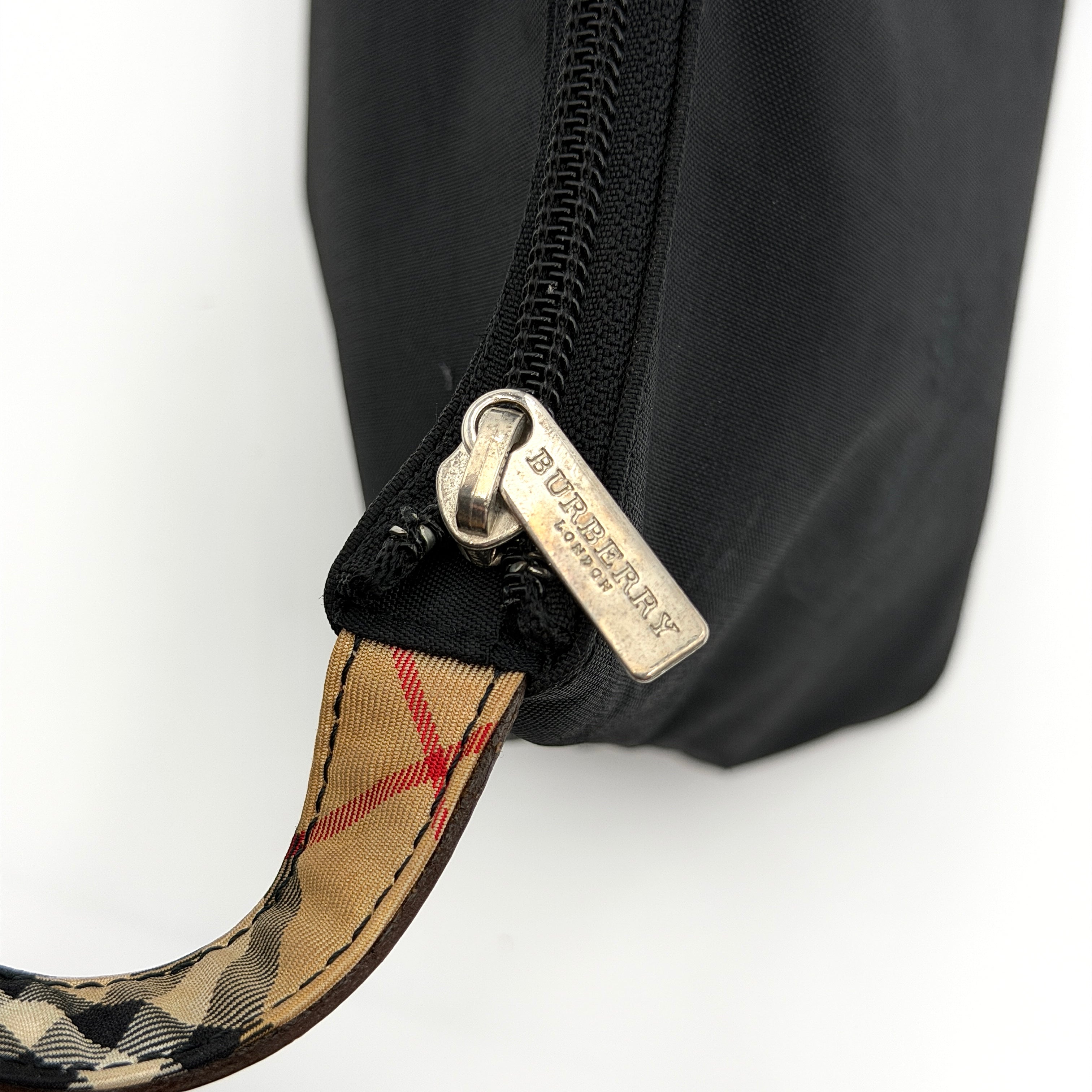 Front-facing Burberry Nova Check Nylon Shoulder Bag in black with Nova Check strap and base, shown against a clean background.