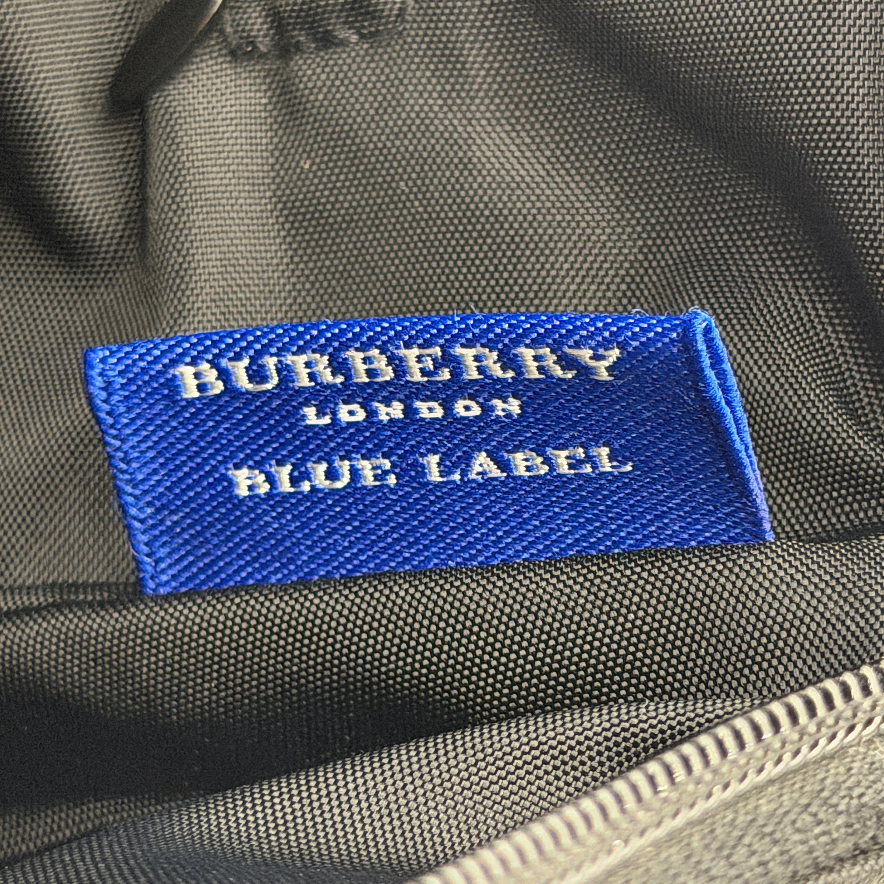 Front-facing Burberry Nova Check Nylon Shoulder Bag in black with Nova Check strap and base, shown against a clean background.