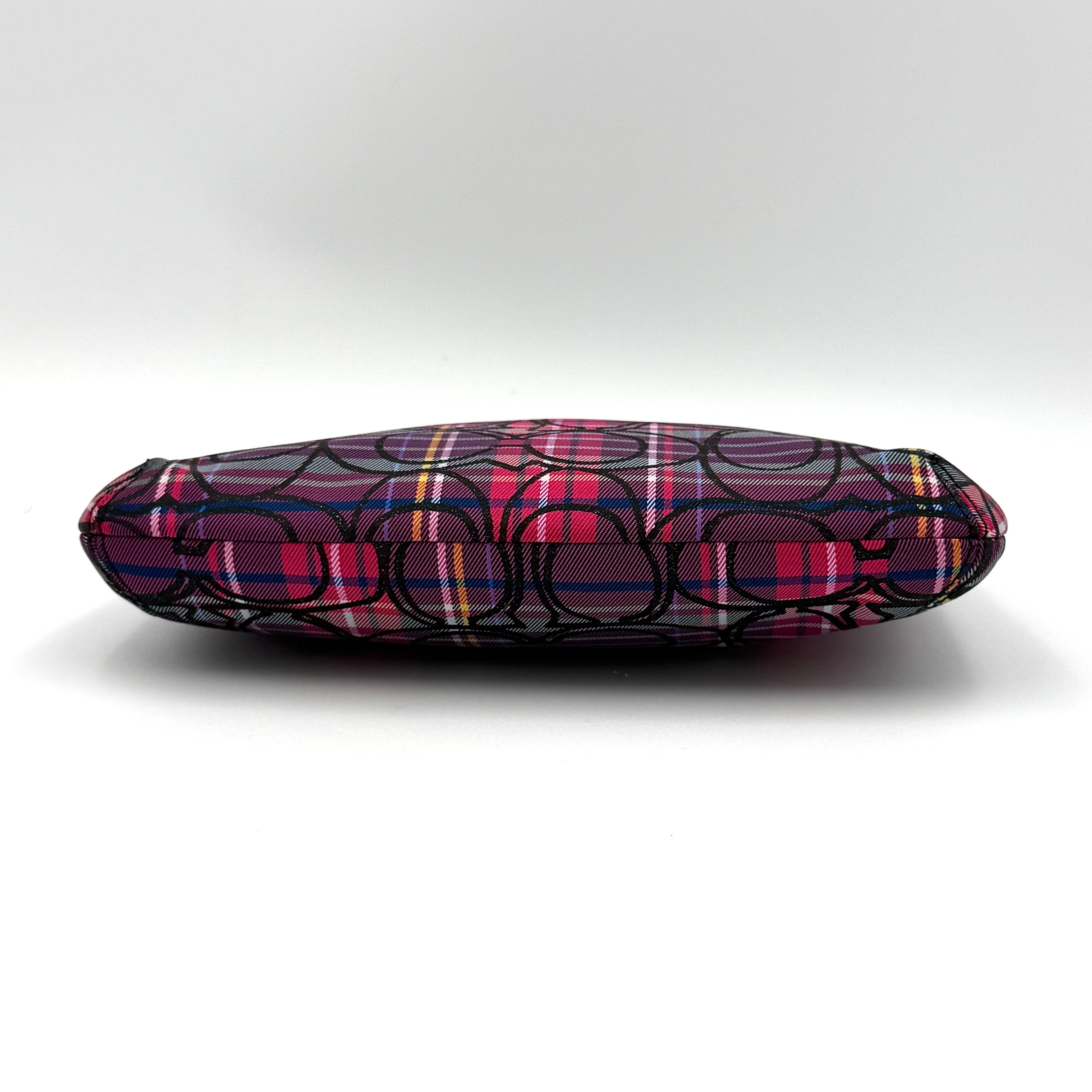 Coach Signature Poppy Tartan Pouch with bold multicolour plaid and black C motif, topped by silver-tone hardware and leather zipper pull.