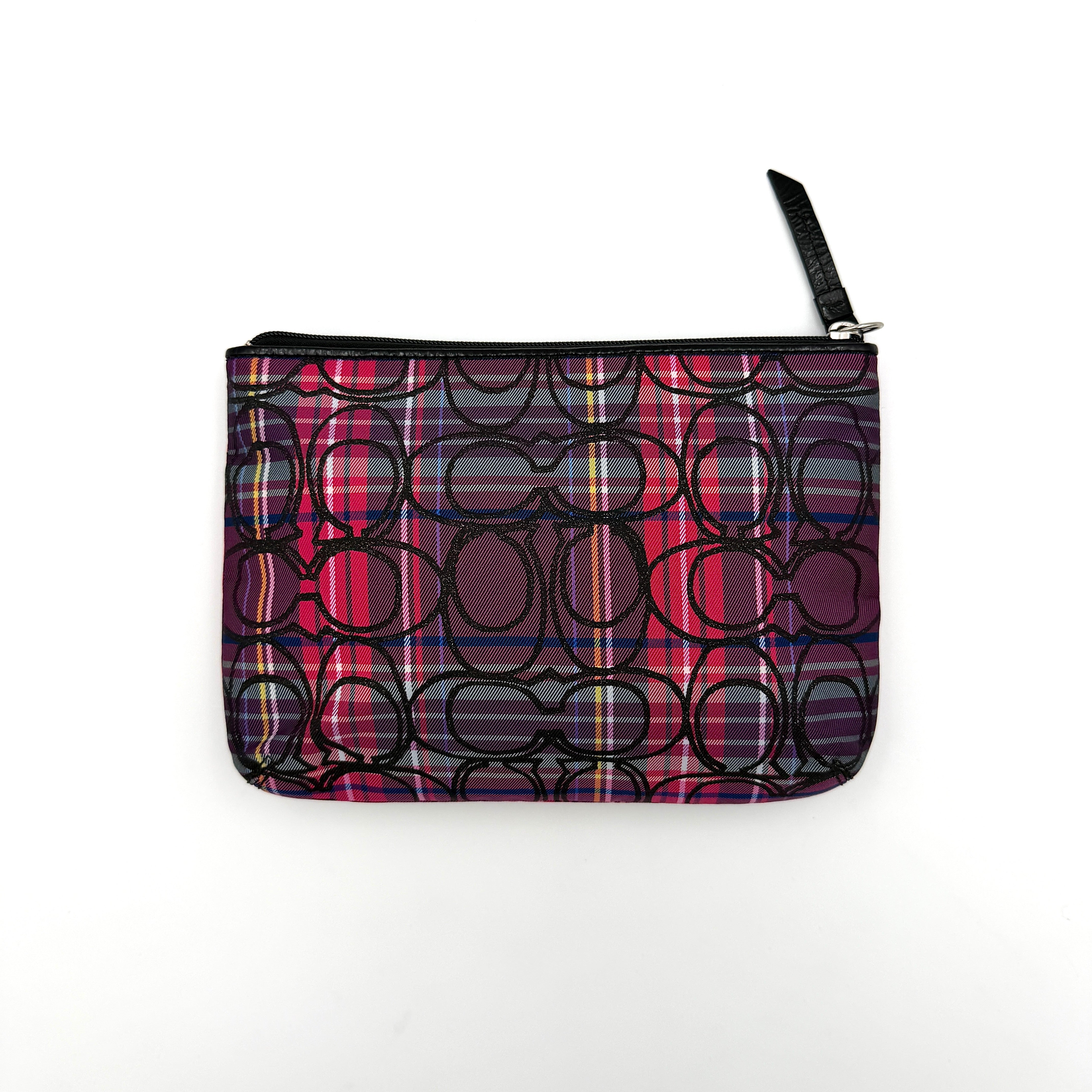 Coach Signature Poppy Tartan Pouch with bold multicolour plaid and black C motif, topped by silver-tone hardware and leather zipper pull.