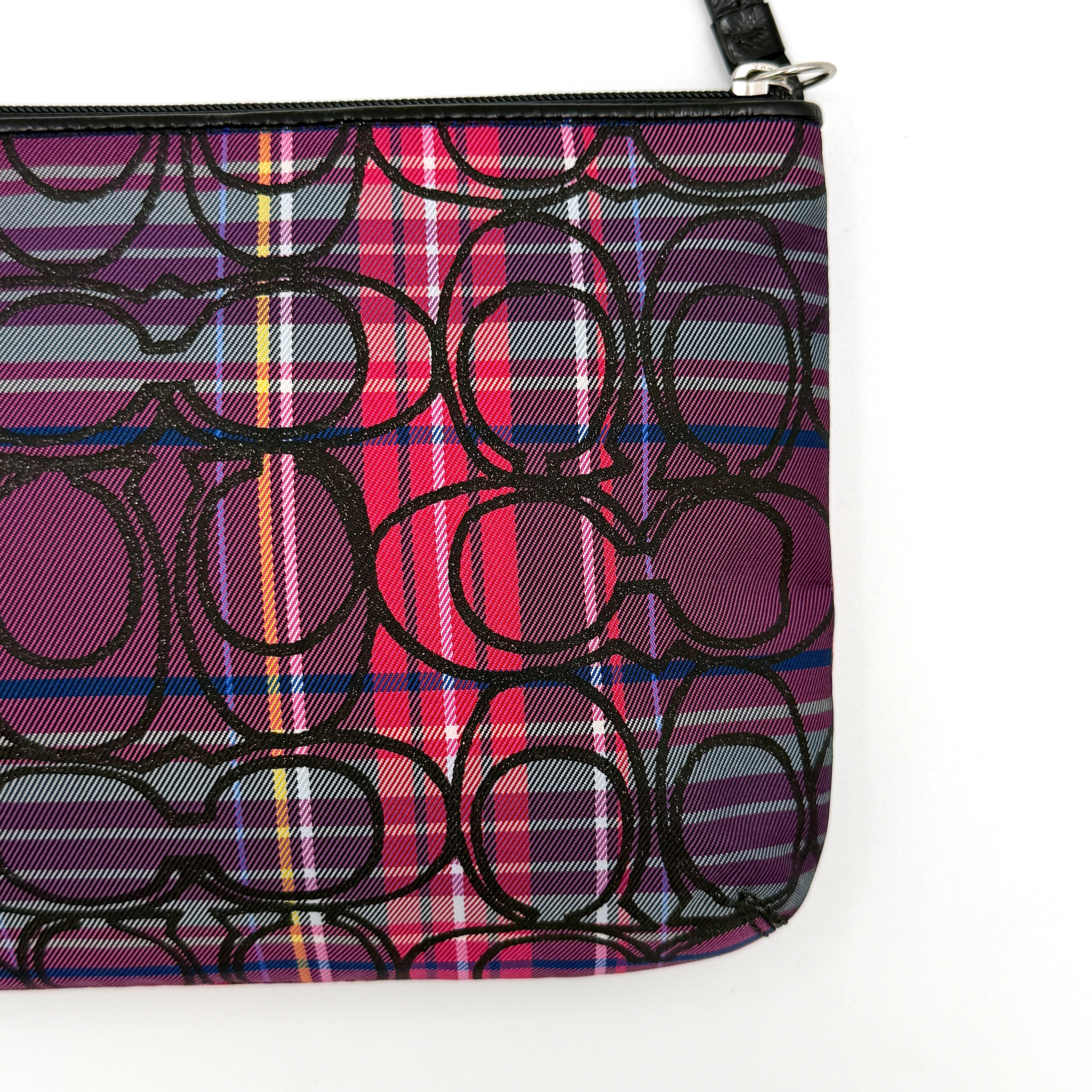 Coach Signature Poppy Tartan Pouch with bold multicolour plaid and black C motif, topped by silver-tone hardware and leather zipper pull.