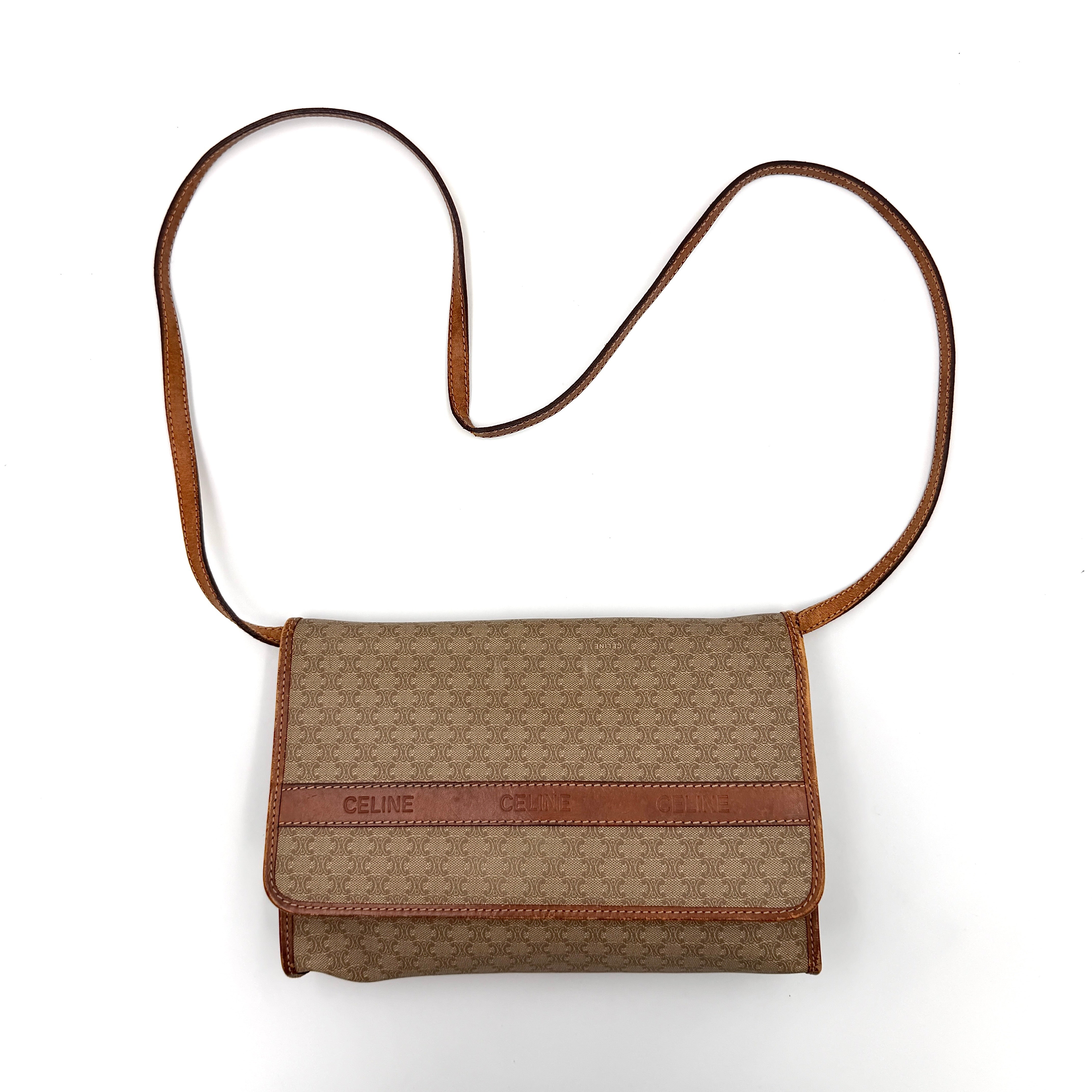 Celine Macadam PVC Crossbody Bag in brown and beige with a monogram pattern, tan leather trim, and long crossbody strap displayed against a white background.