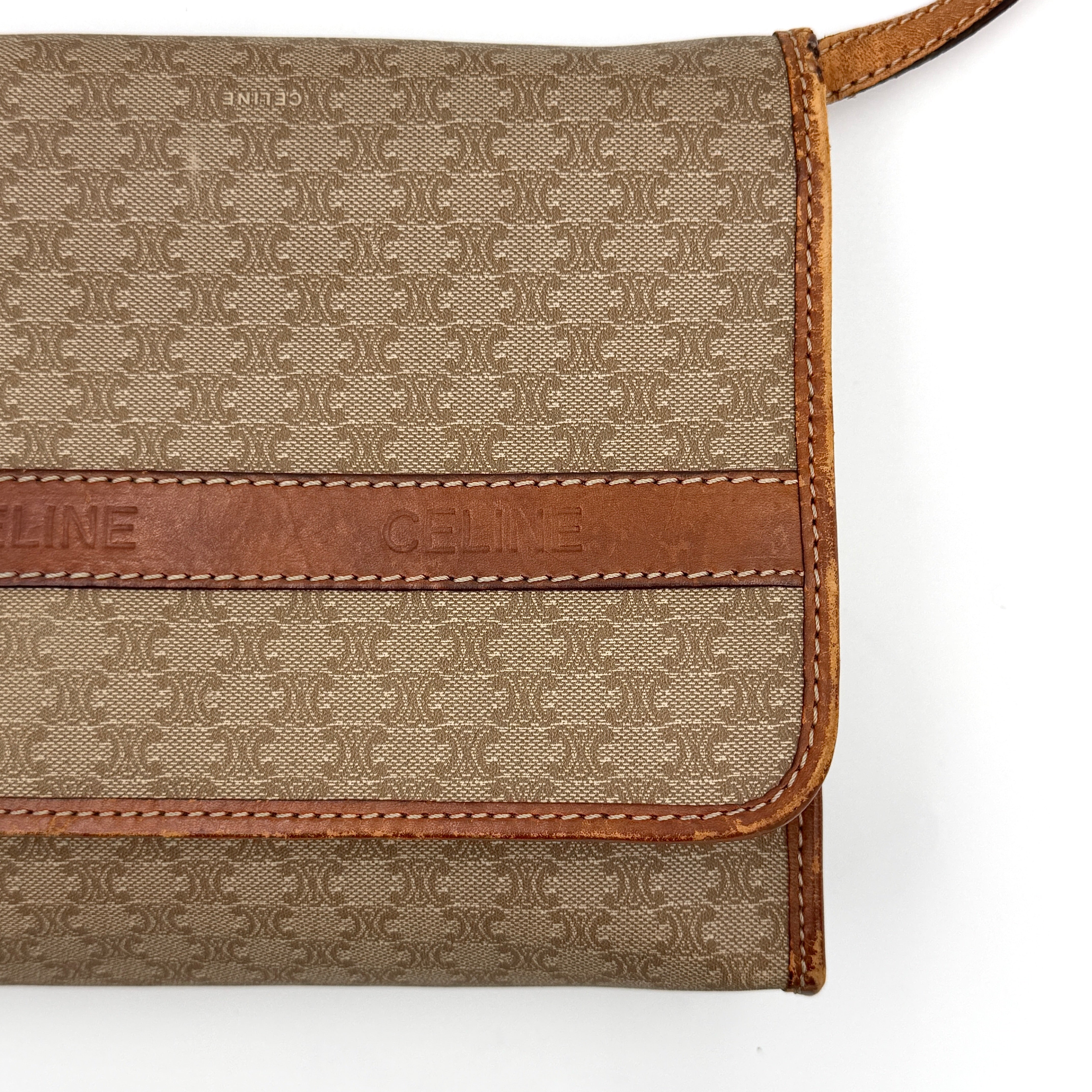Celine Macadam PVC Crossbody Bag in brown and beige with a monogram pattern, tan leather trim, and long crossbody strap displayed against a white background.