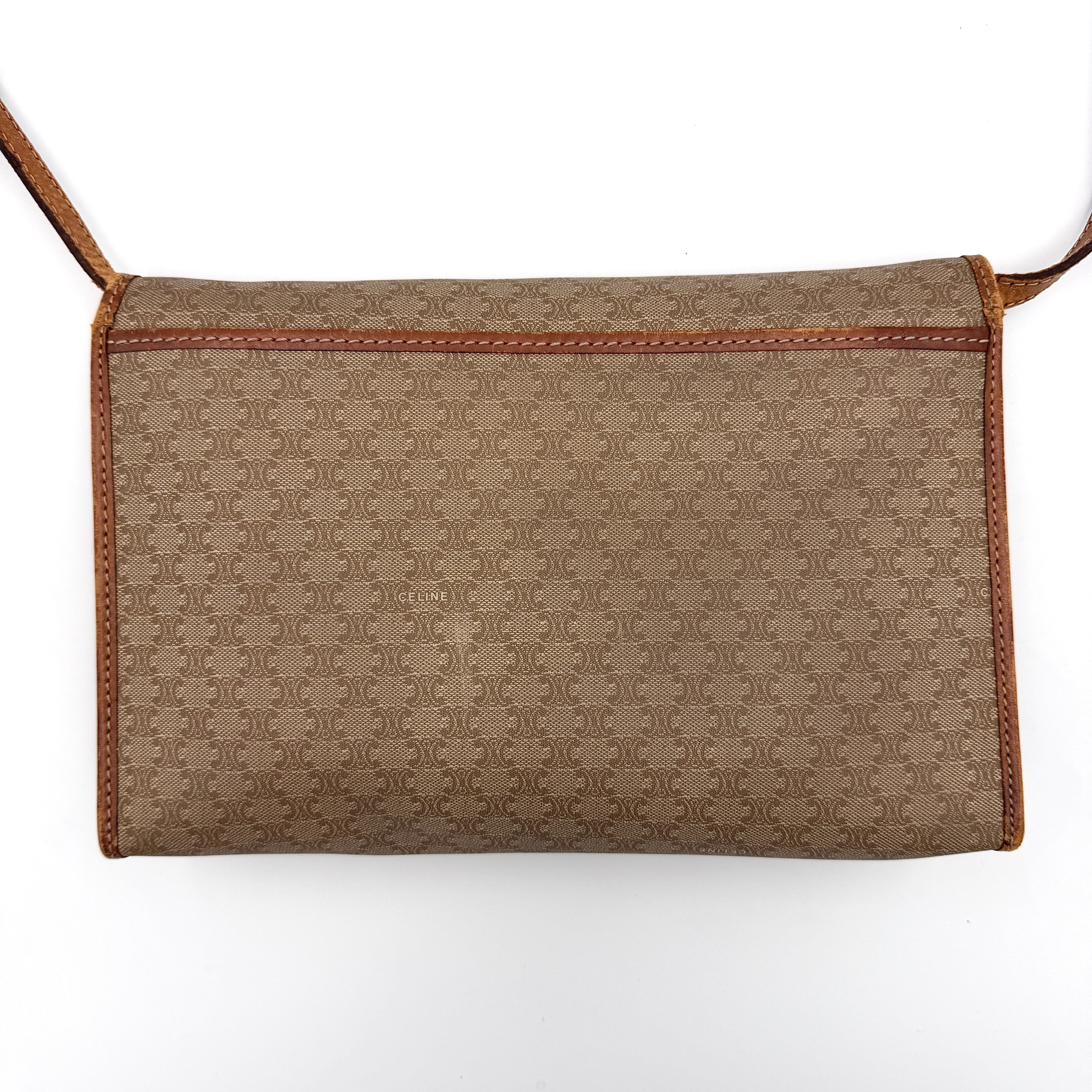 Celine Macadam PVC Crossbody Bag in brown and beige with a monogram pattern, tan leather trim, and long crossbody strap displayed against a white background.