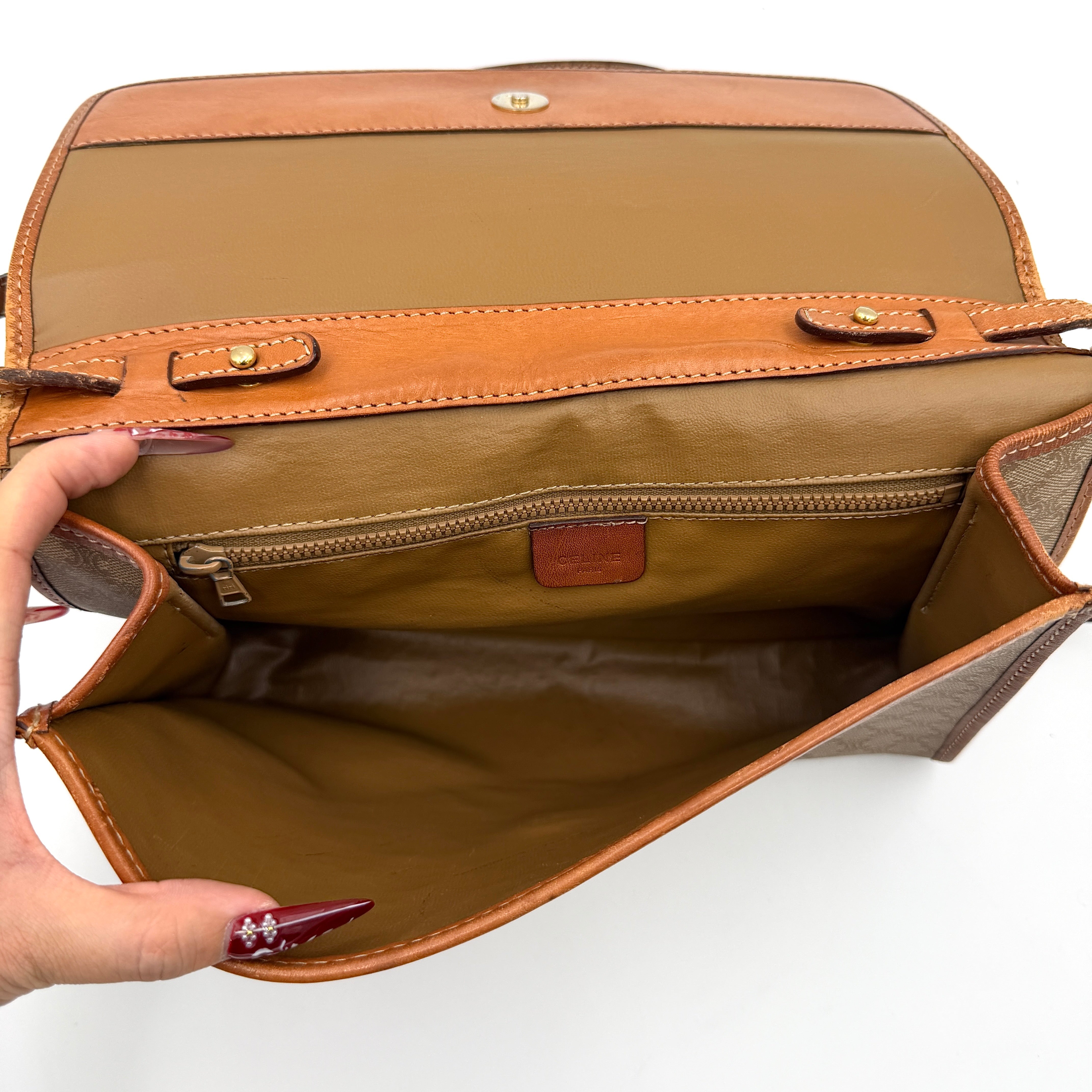 Celine Macadam PVC Crossbody Bag in brown and beige with a monogram pattern, tan leather trim, and long crossbody strap displayed against a white background.