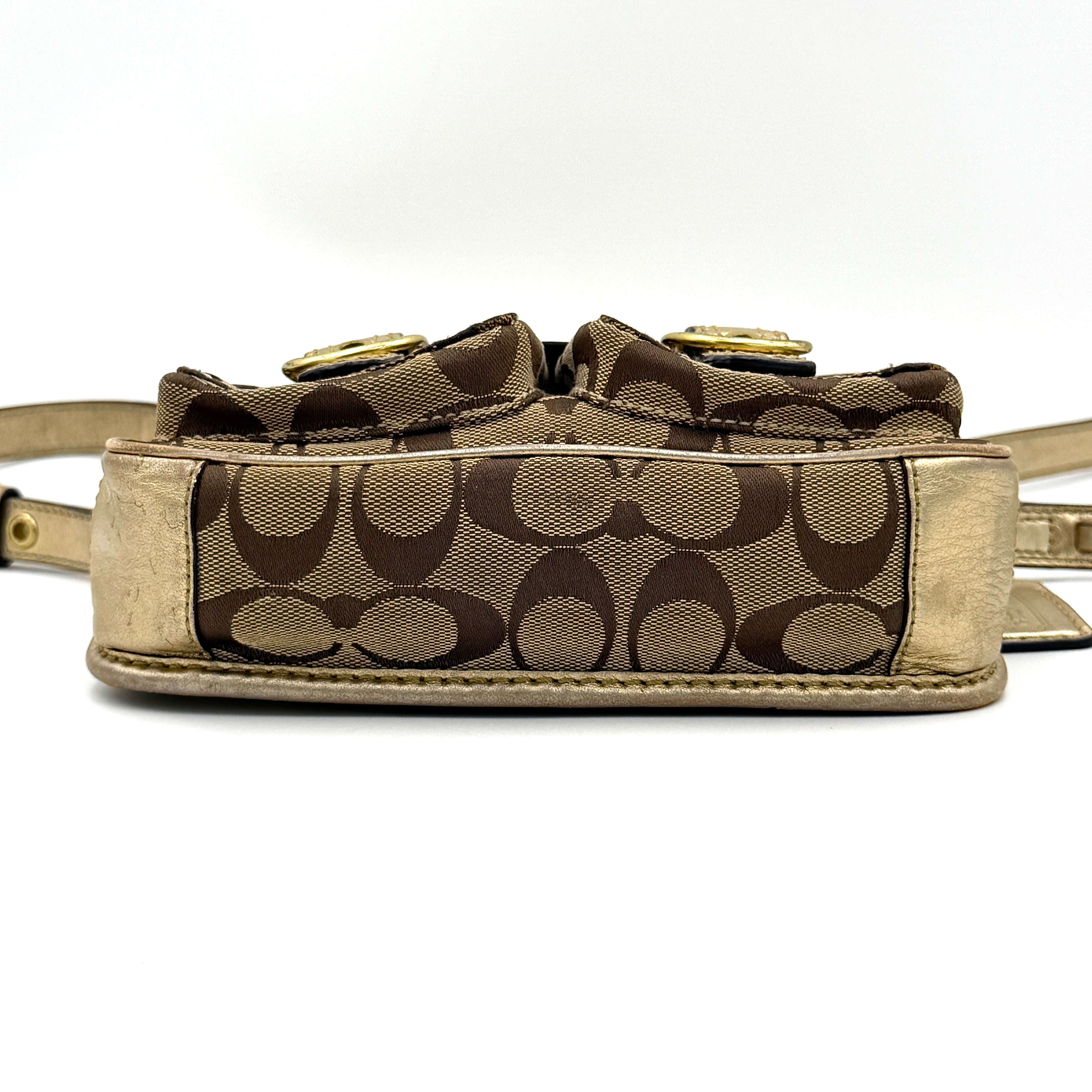 Coach Bleecker crossbody bag in gold metallic leather and beige monogram canvas with double front buckle details.