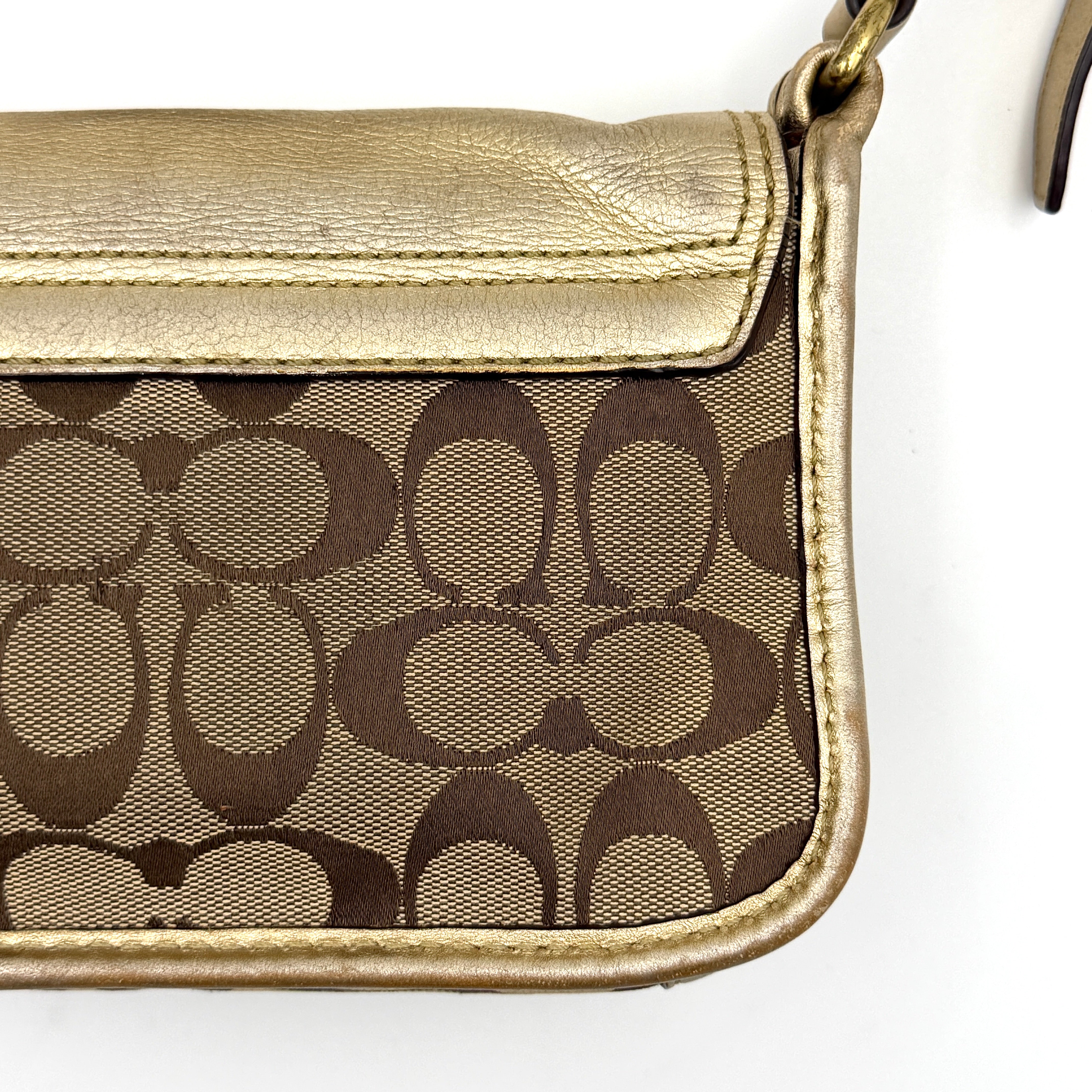 Coach Bleecker crossbody bag in gold metallic leather and beige monogram canvas with double front buckle details.