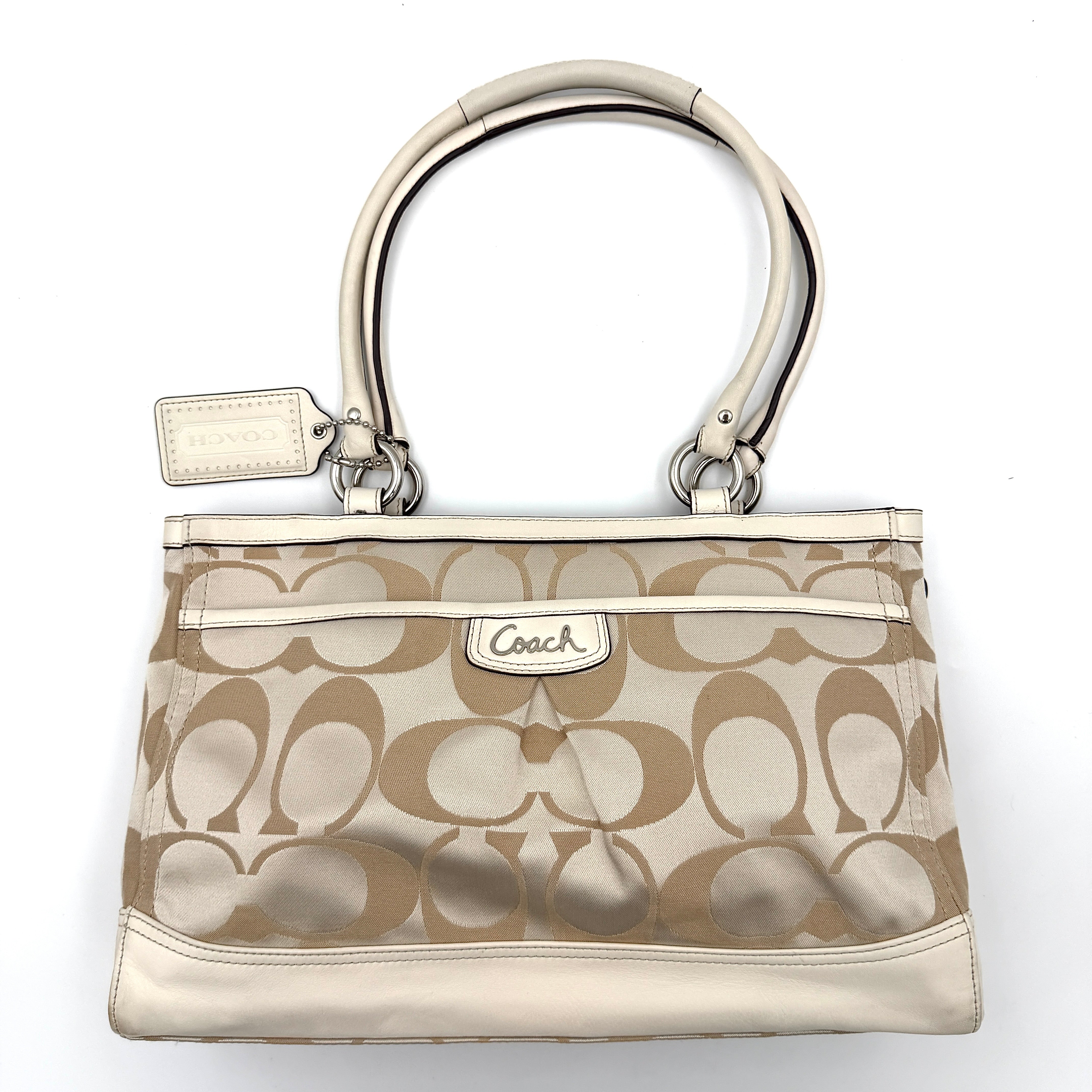 Coach Signature Carryall Shoulder Bag in beige jacquard canvas with cream leather trim and silver hardware displayed against a white background.