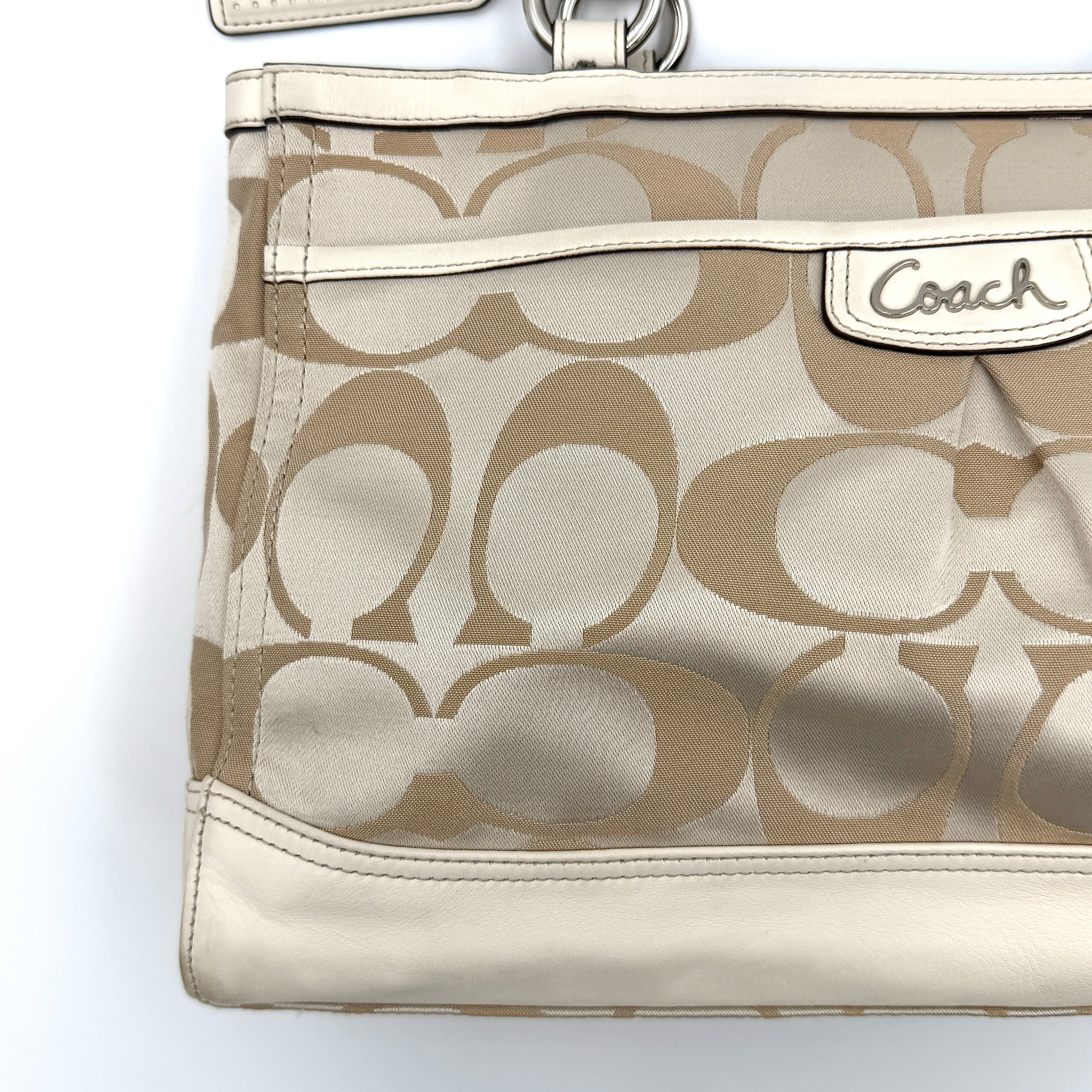 Coach Signature Carryall Shoulder Bag in beige jacquard canvas with cream leather trim and silver hardware displayed against a white background.