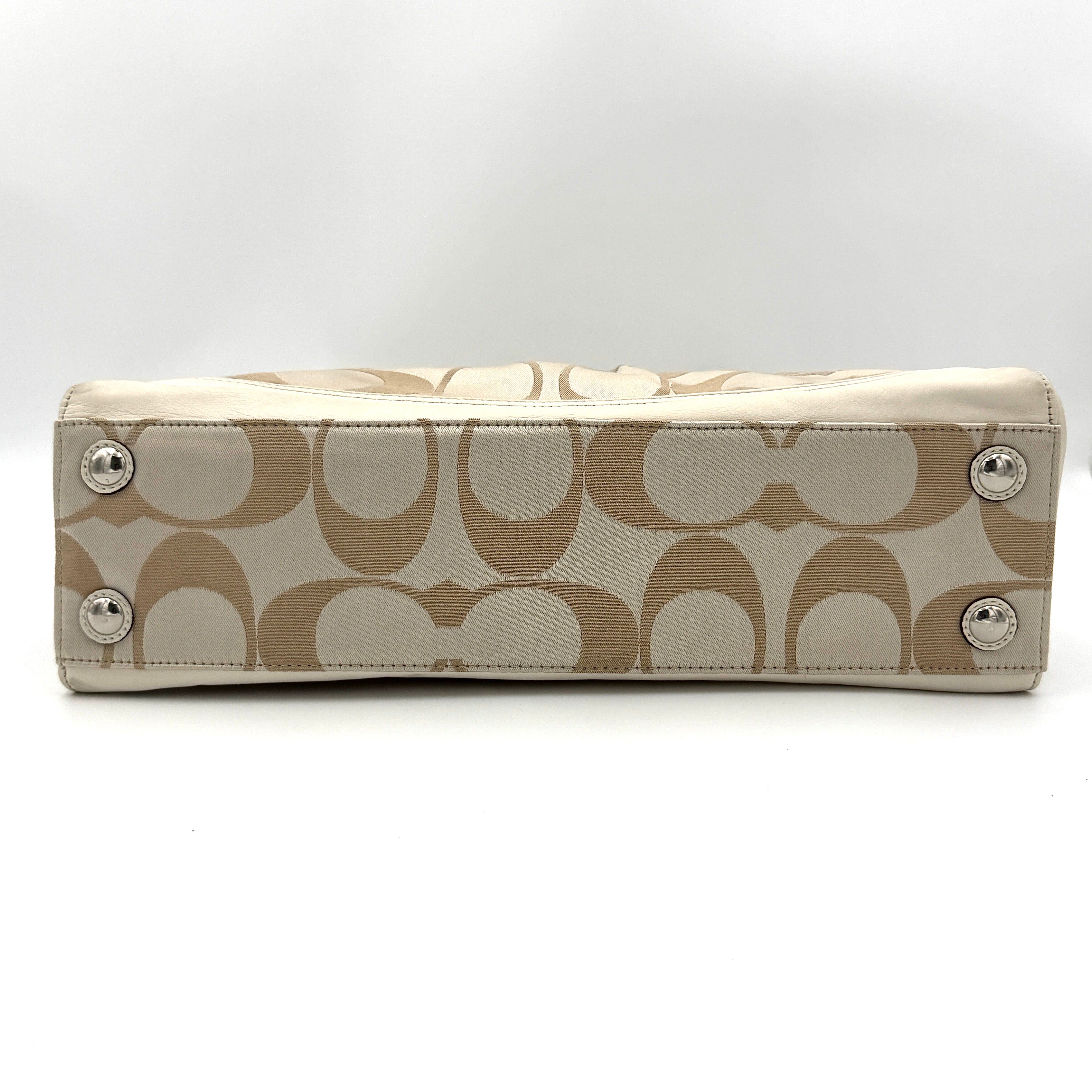 Coach Signature Carryall Shoulder Bag in beige jacquard canvas with cream leather trim and silver hardware displayed against a white background.