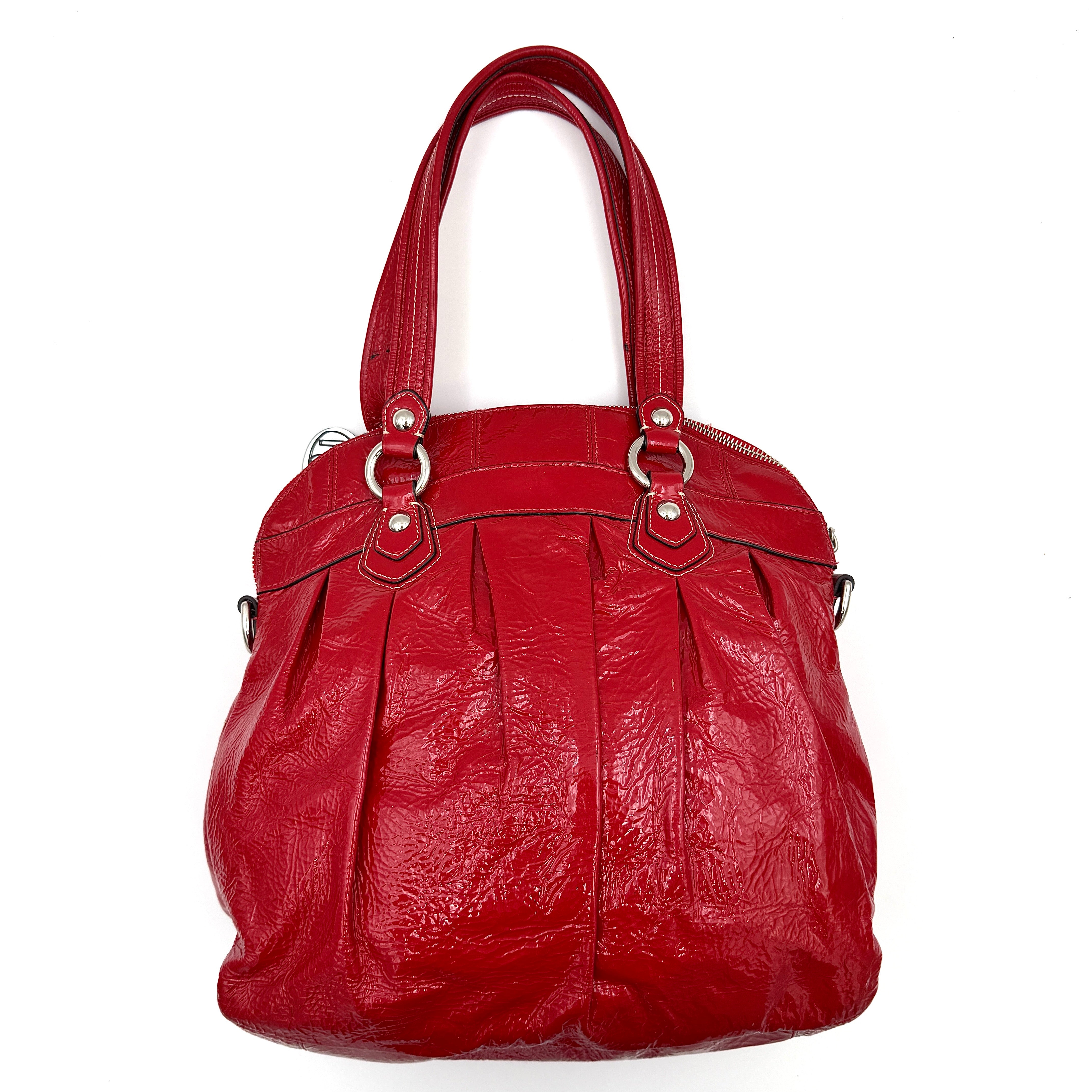 Coach Poppy 2Way shoulder bag in glossy red patent leather with floral appliqué, heart charm, double handles and detachable long strap.