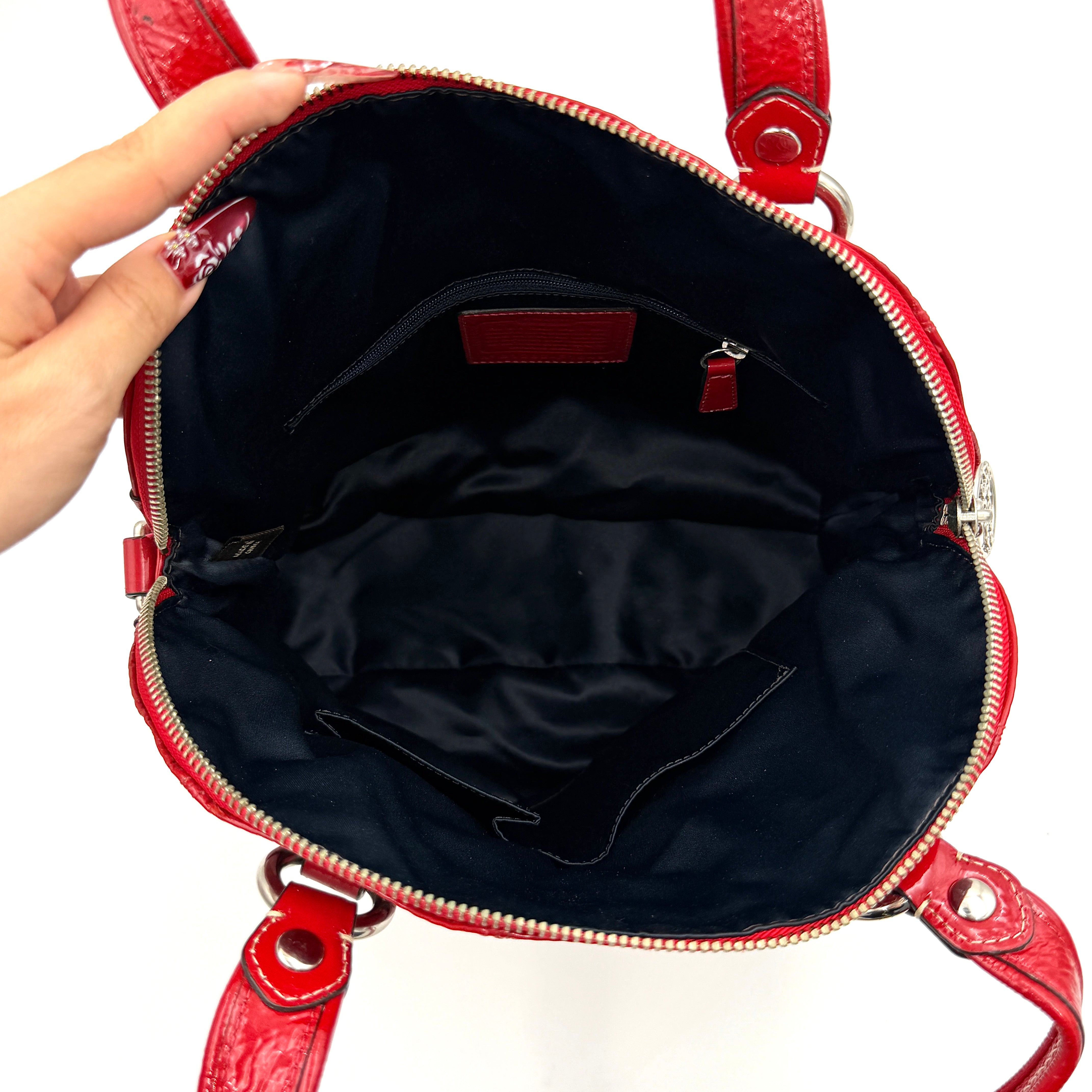 Coach Poppy 2Way shoulder bag in glossy red patent leather with floral appliqué, heart charm, double handles and detachable long strap.