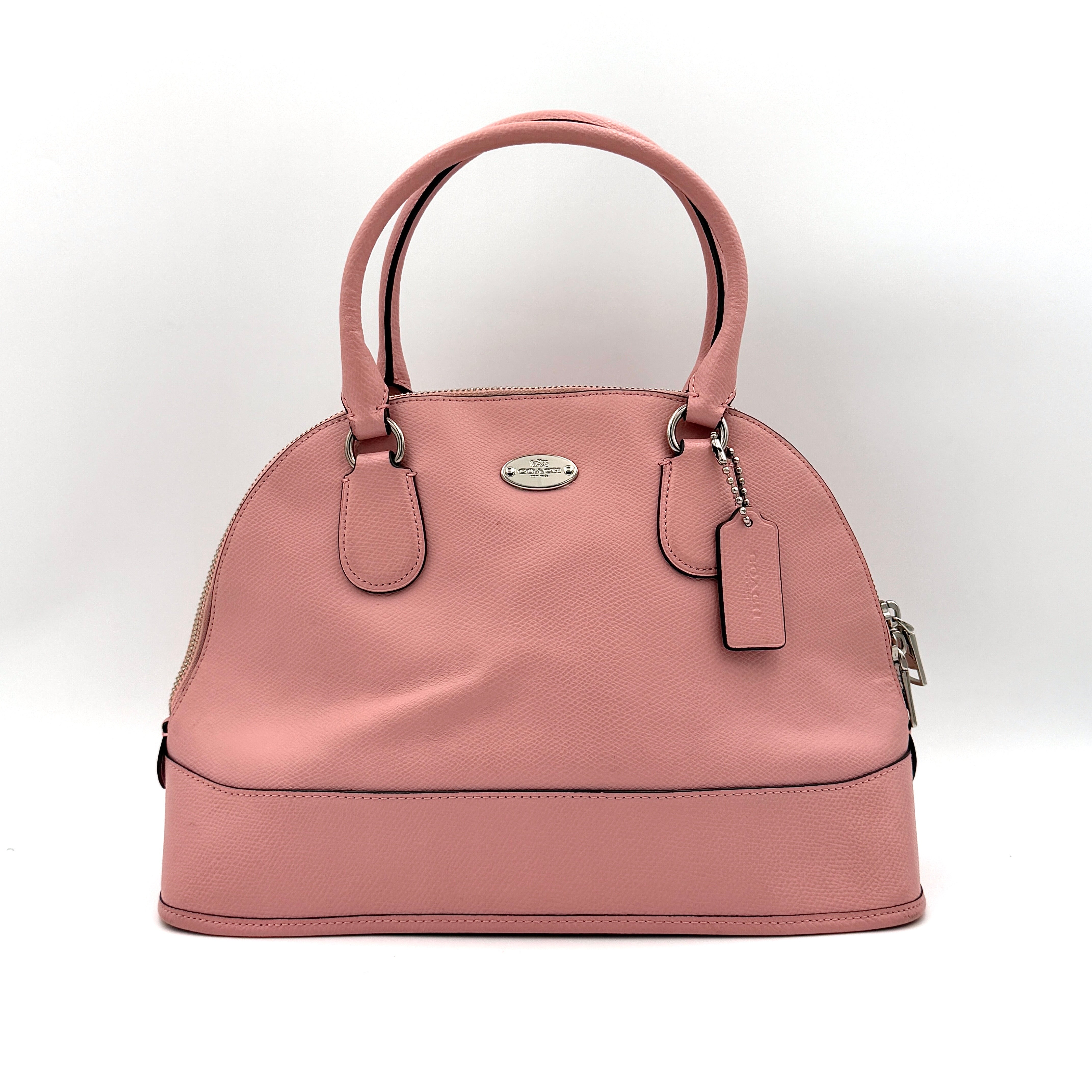 Coach Cora Domed Handbag in light pink leather with silver hardware, styled with double handles and detachable strap.