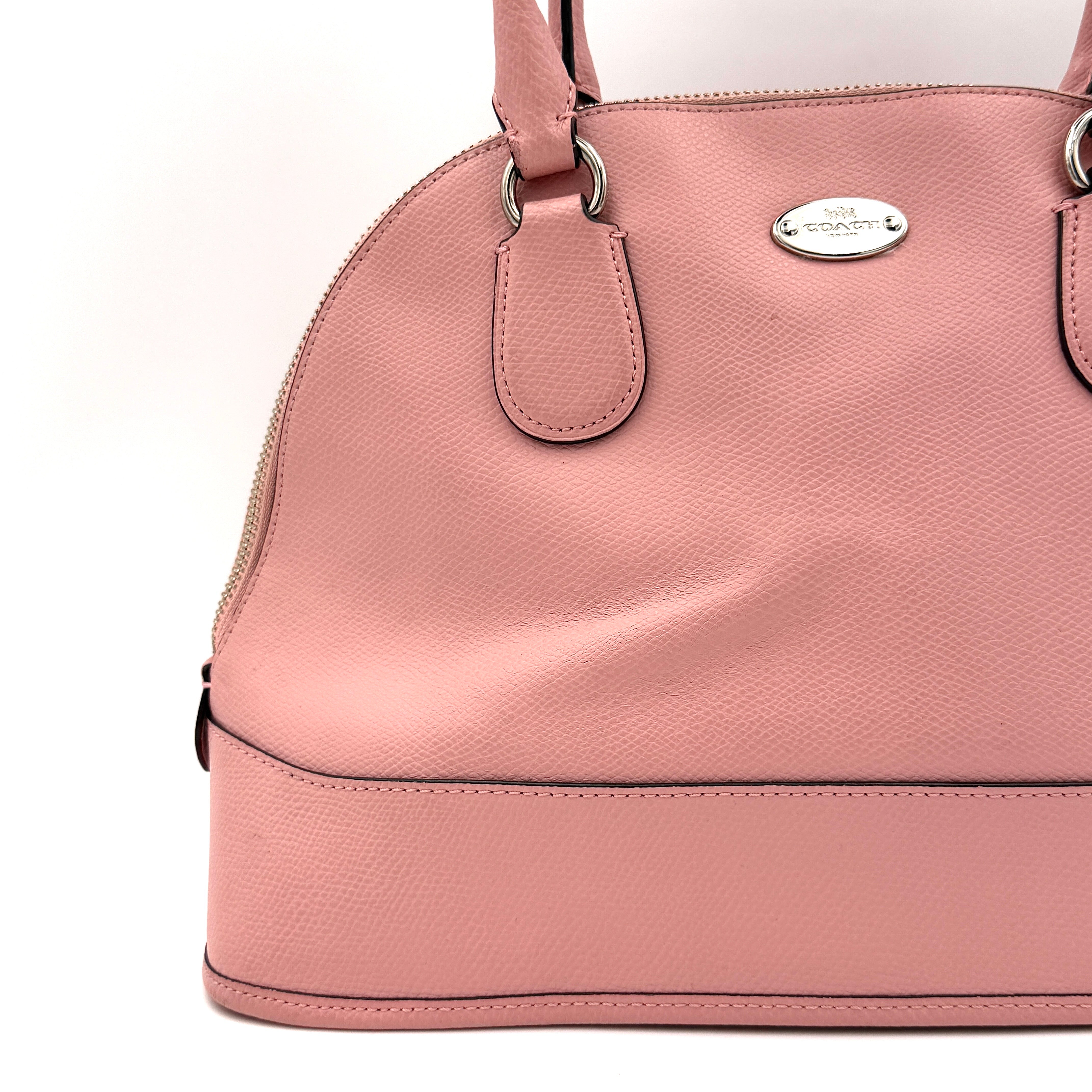 Coach Cora Domed Handbag in light pink leather with silver hardware, styled with double handles and detachable strap.
