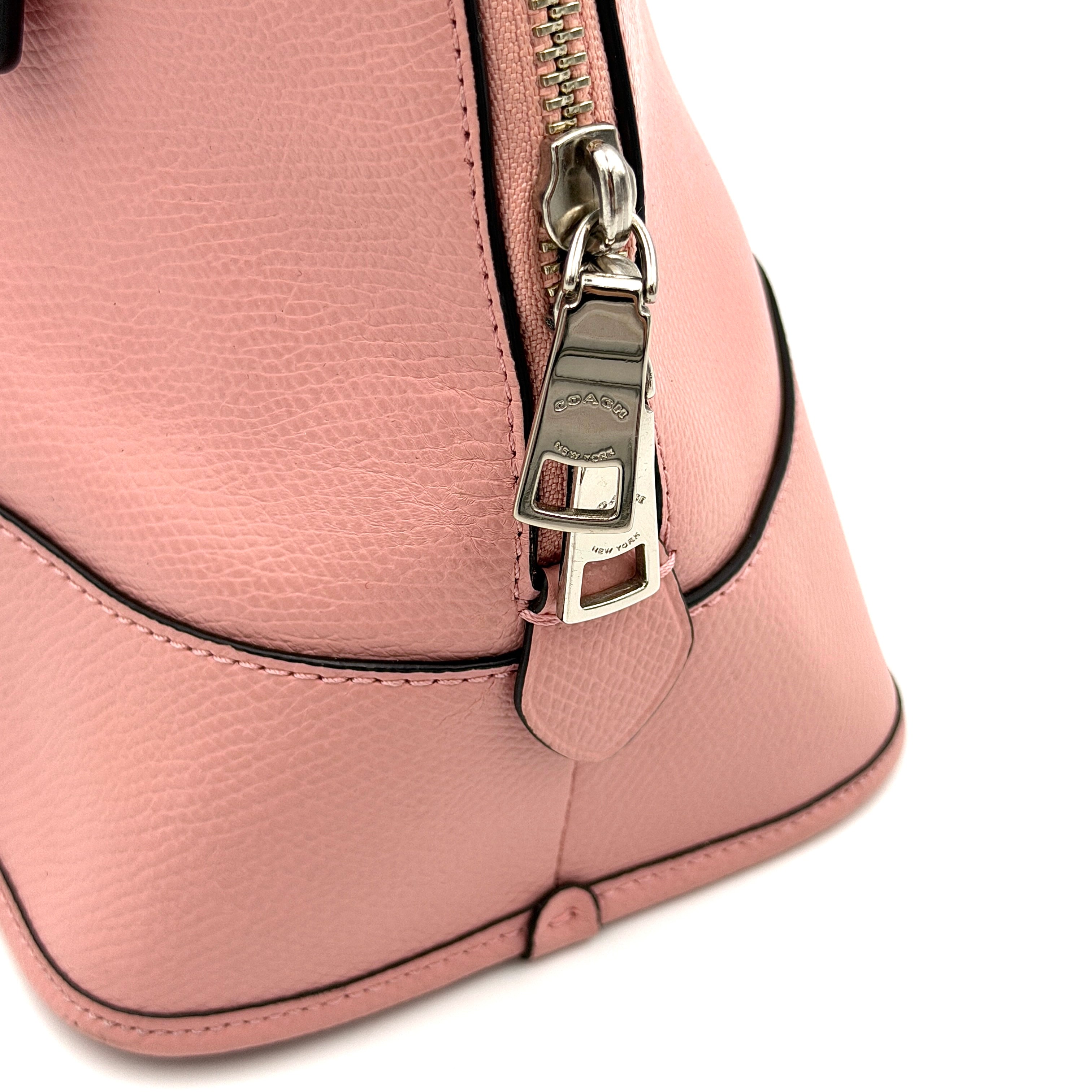 Coach Cora Domed Handbag in light pink leather with silver hardware, styled with double handles and detachable strap.