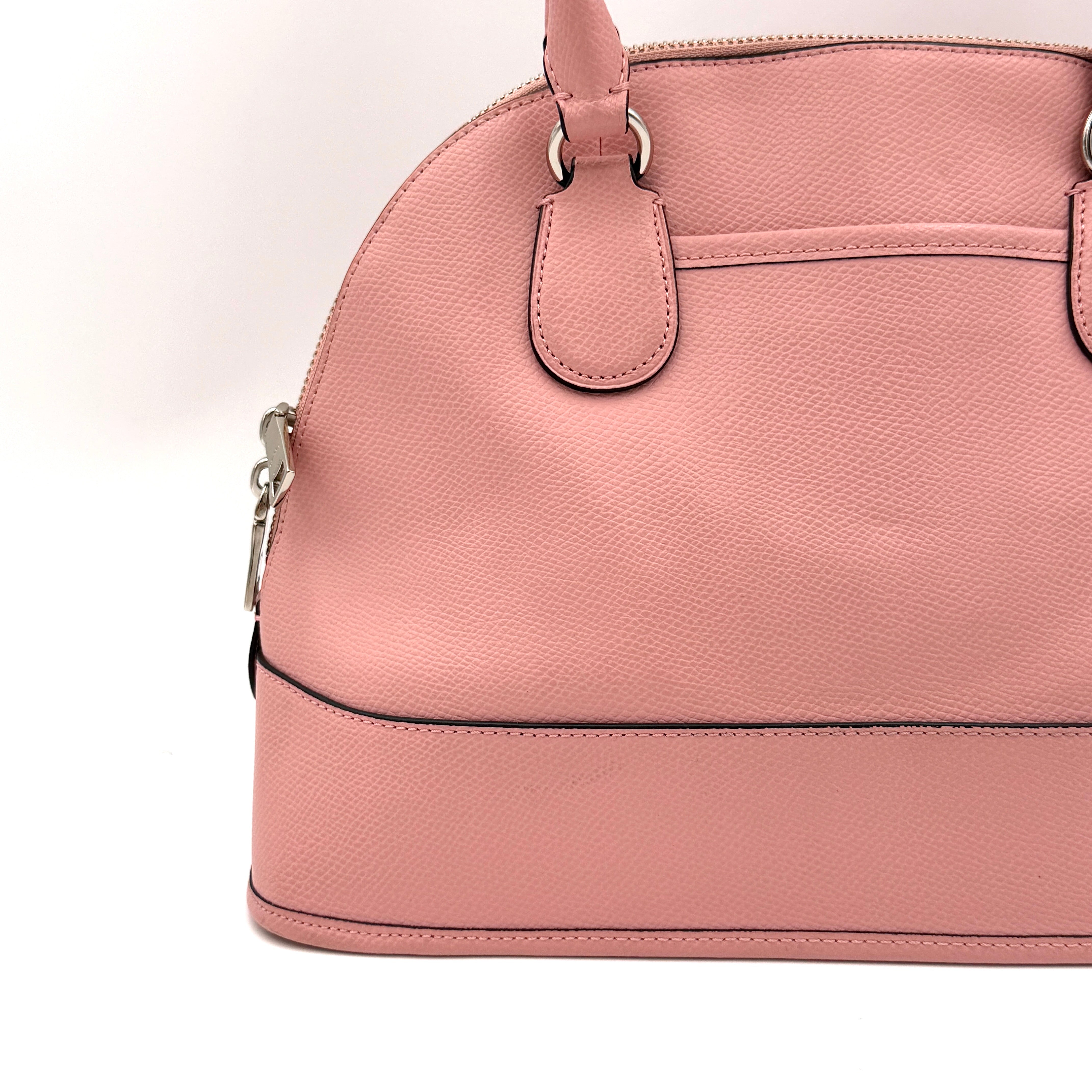 Coach Cora Domed Handbag in light pink leather with silver hardware, styled with double handles and detachable strap.