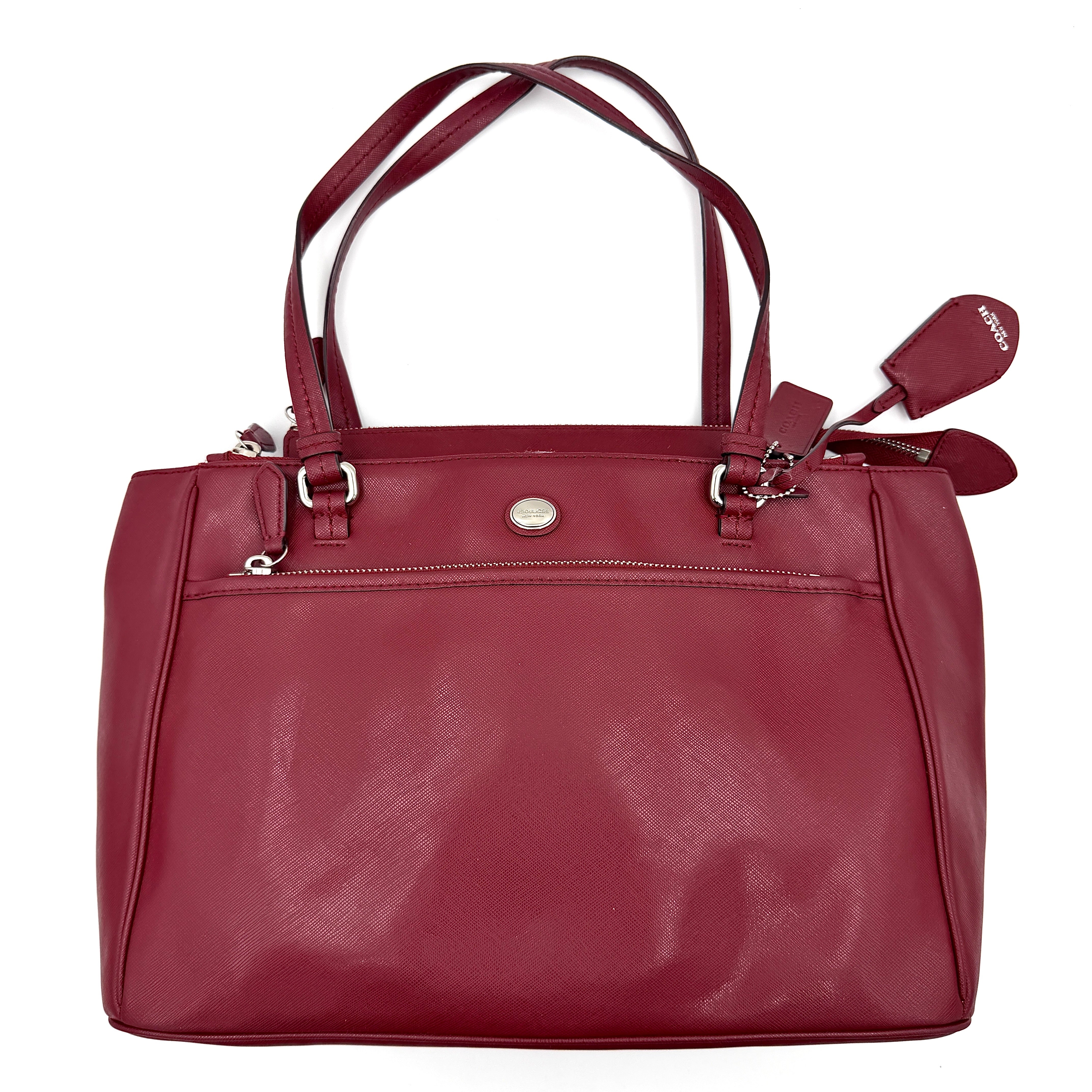 Coach 2Way Peyton Carryall Shoulder Bag in maroon leather with silver hardware, top handles, and detachable strap styled beside the bag.